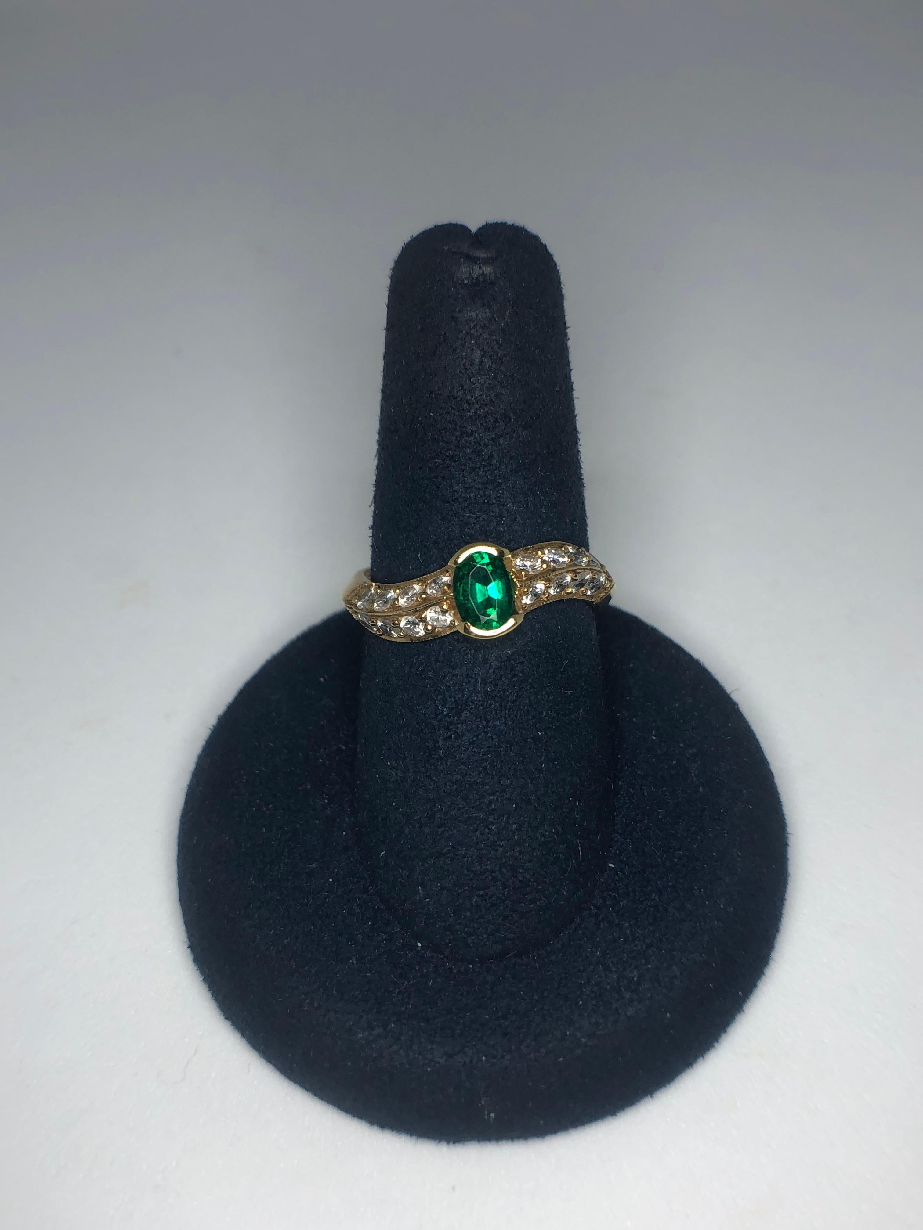 Lady's 18kt yellow gold emerald and diamond ring by Armand Jacoby/Celebrity, 1 - oval emerald = .47ct total weight, diamonds = .52ct, average color G-H, average clarity SI1. Size 6.75