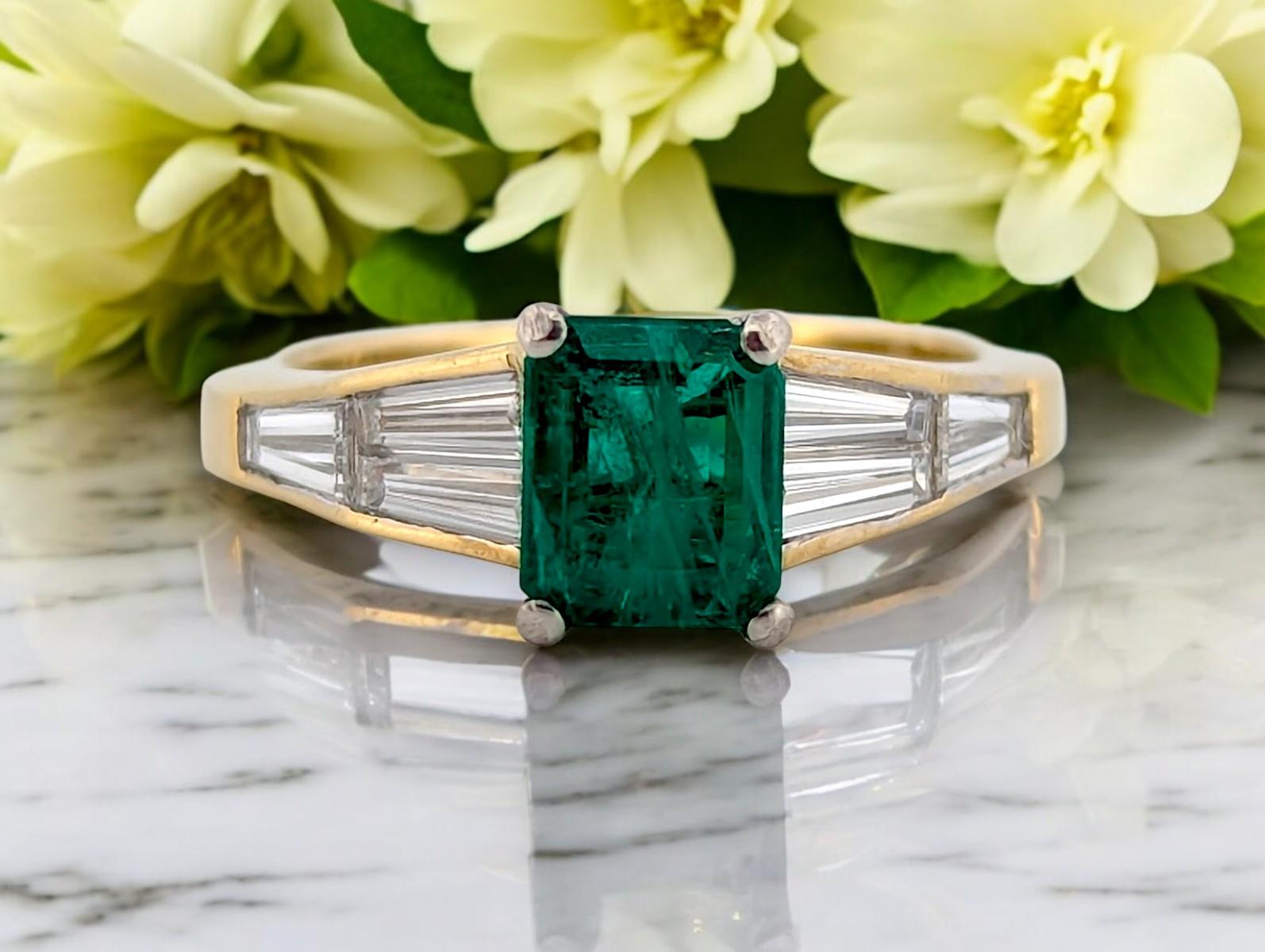 Bold, elegant, and timeless—this 18k yellow gold emerald and diamond ring from Mountain Song Jewelers is a breathtaking statement of refined luxury. Featuring a stunning natural emerald cut emerald at the center, flanked by .75 CTW of natural