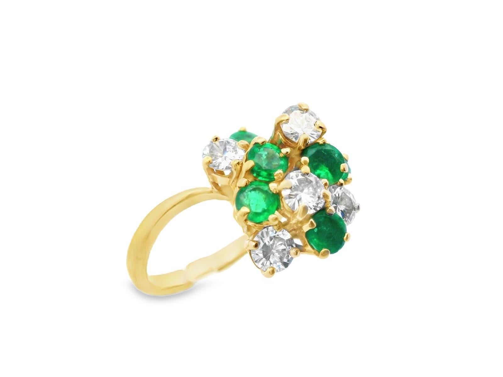 Dieser wunderschöne Cluster-Ring ist aus 18 Karat Gelbgold gefertigt und mit strahlend weißen Diamanten und sattgrünen Smaragden besetzt. Sowohl die Diamanten als auch die Smaragde sind rund geschliffen und in dem Cluster zufällig gemischt. Das