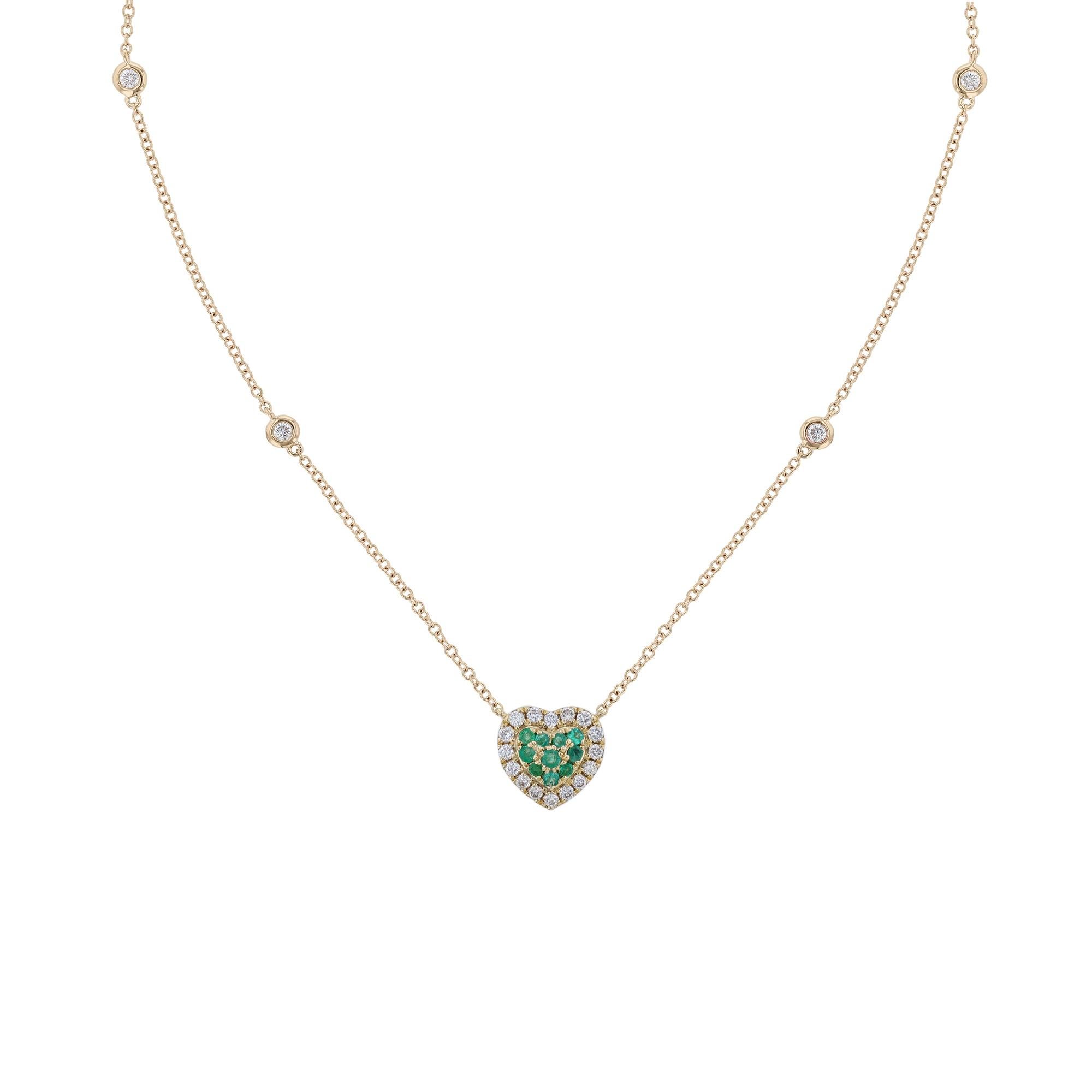 This pendant necklace is made in 18K yellow gold. It features a heart shape pendant with 10 round cut, pave' set emeralds. Surrounded by a halo of 15 pave' set, round cut diamonds. With 4 round cut, bezel diamond stations on the chain. The necklace