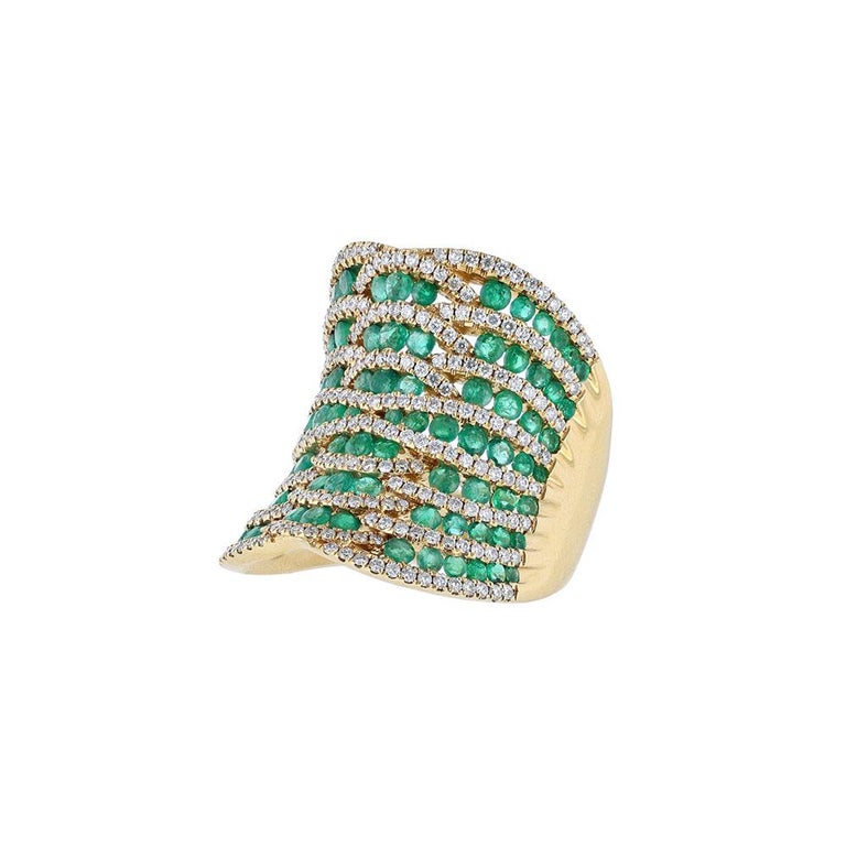 This ring is made in 18K yellow gold and features 72 round-cut emeralds weighing 2.92 carats. It also features 150 round cut diamonds weighing 1.15 carats. With a clarity grade of (SI2). 
