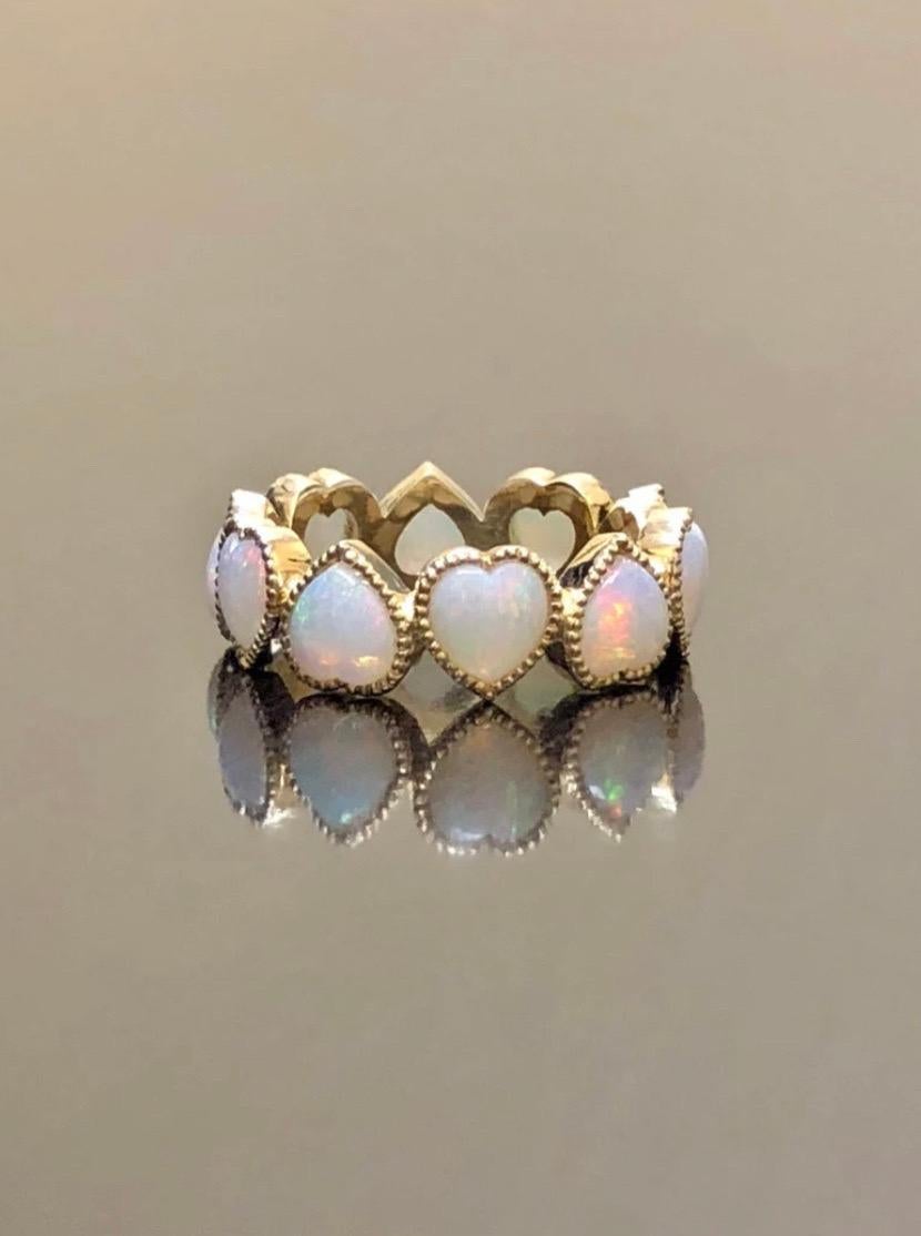 DeKara Designs

Metal- 18K Yellow Gold, .750.

Stones- 9 Plus Hear Shaped Genuine Australian Opals, Number of Opals Depends on Finger Size.

Size- 4-12

Beautiful Entirely Handmade Heart Shaped Australian Opal Eternity Band Made in 18K Yellow Gold.