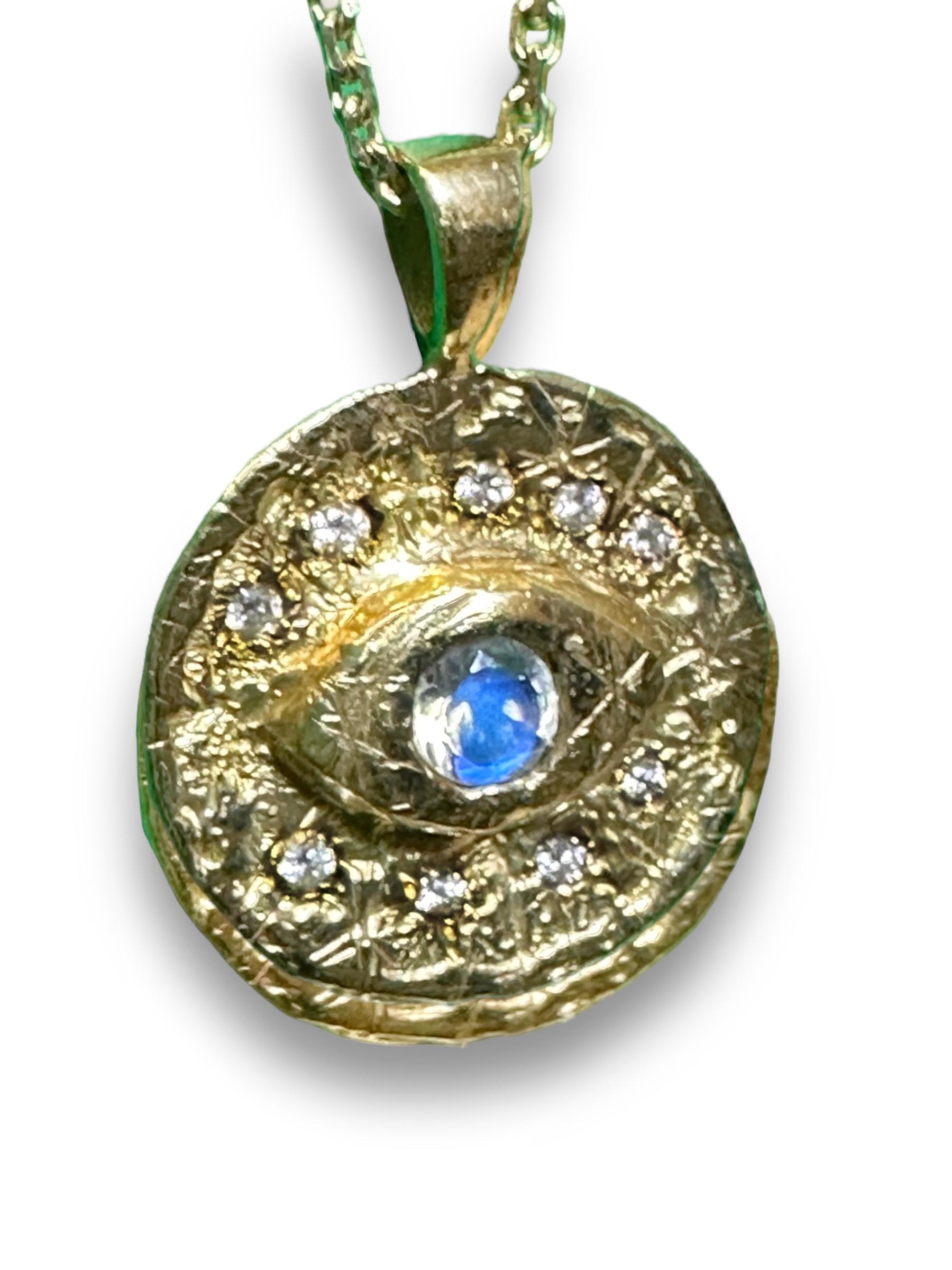 Experience the enchanting allure of history with this one of a kind Eye Coin Talisman Pendant, featuring diamonds and a moonstone set in 18K Yellow Gold. Handcrafted and inspired by the captivating beauty of ancient jewellery, the pendant is a