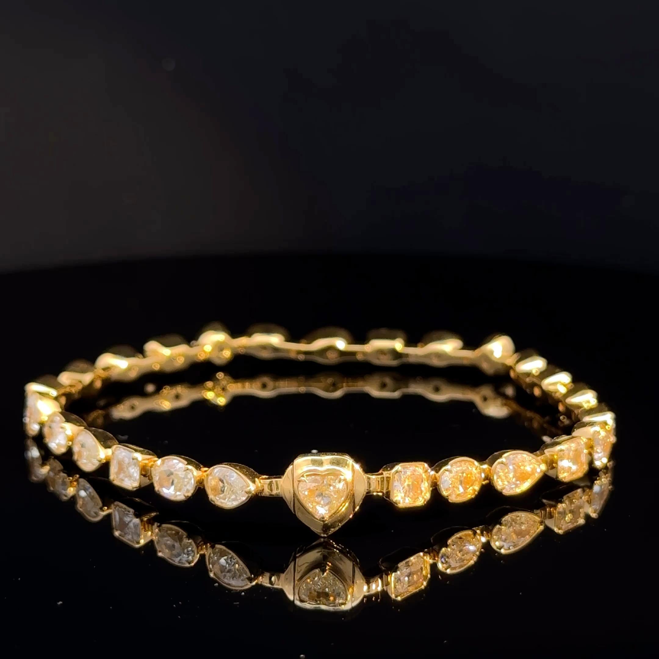 Elevate your collection with this exquisite 18K yellow gold line bracelet set with approximately 9.75 carats of natural fancy yellow diamonds. Each diamond is bezel-set in a refined array of mixed cuts—pear, round, oval, and cushion—creating a