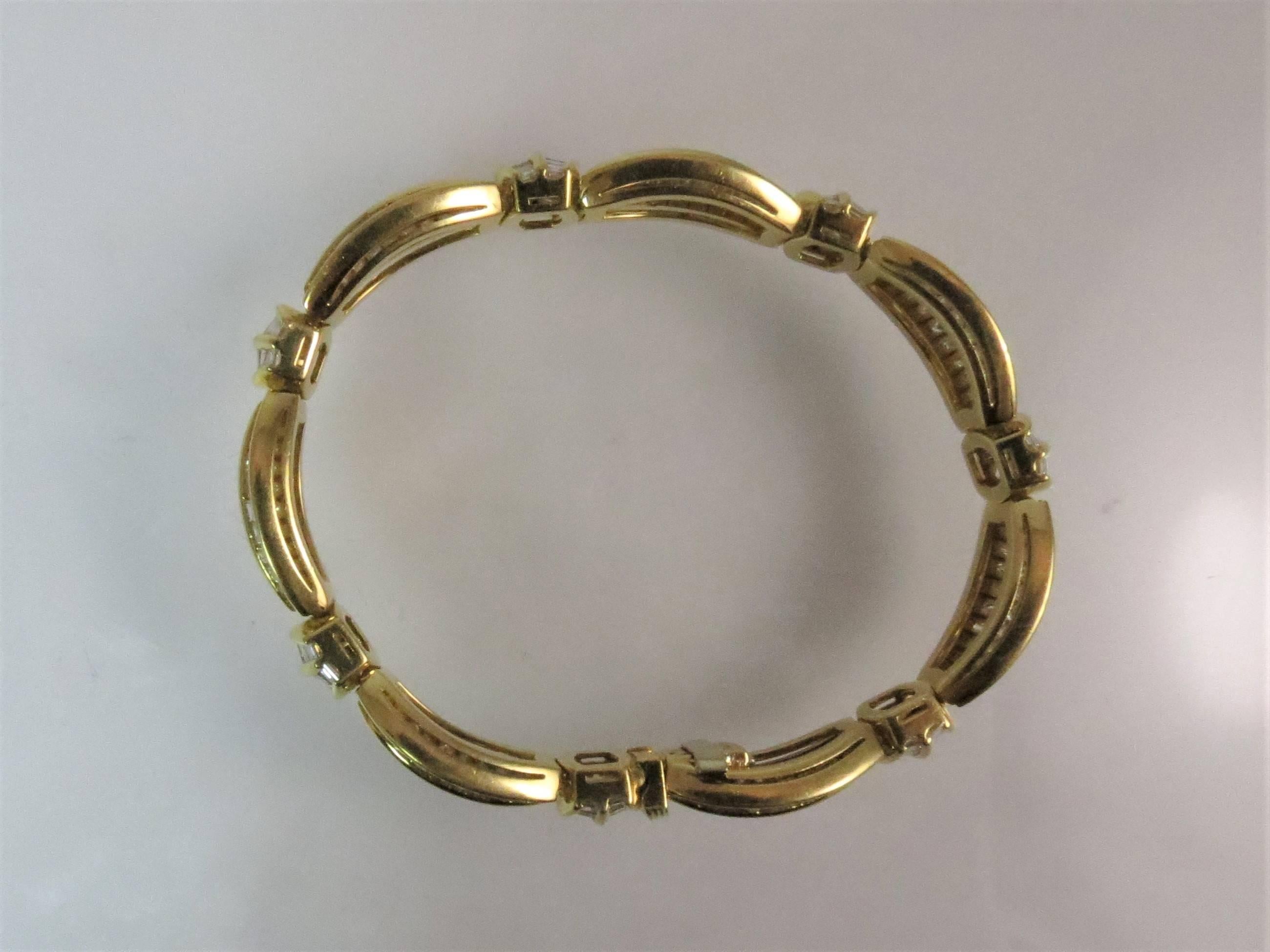 18K yellow gold flexible bracelet, set with 315 baguette diamonds weighing 16.82cts, G-H color, VS clarity.