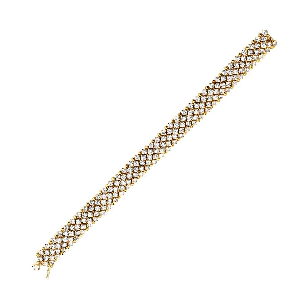 This multi row round diamond bracelet is set in flexible 18K yellow gold. The diamonds wight approx 22.00 ct. G VS quality. 65.2 grams total weight. 7 millimeter thickness. 7 1/4 inch length. Made in Italy. 

Resizeable upon request.

Viewings