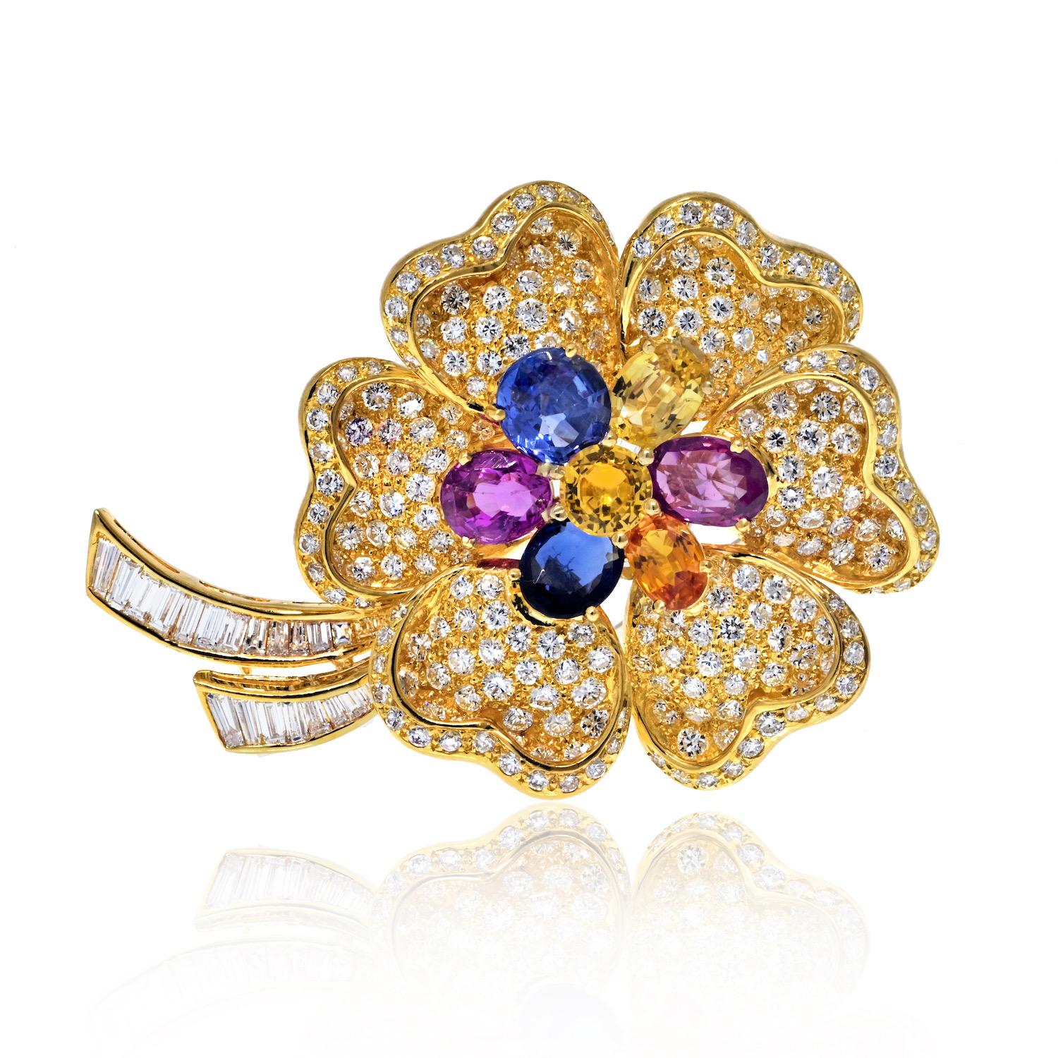 The estate 18K yellow gold diamond and multicolor sapphire flower brooch is a beautiful and intricate piece of jewelry. Here are the details:

- **Material:** 18K yellow gold
- **Dimensions:** 2 inches long and 1.5 inches wide
- **Diamonds:** Most