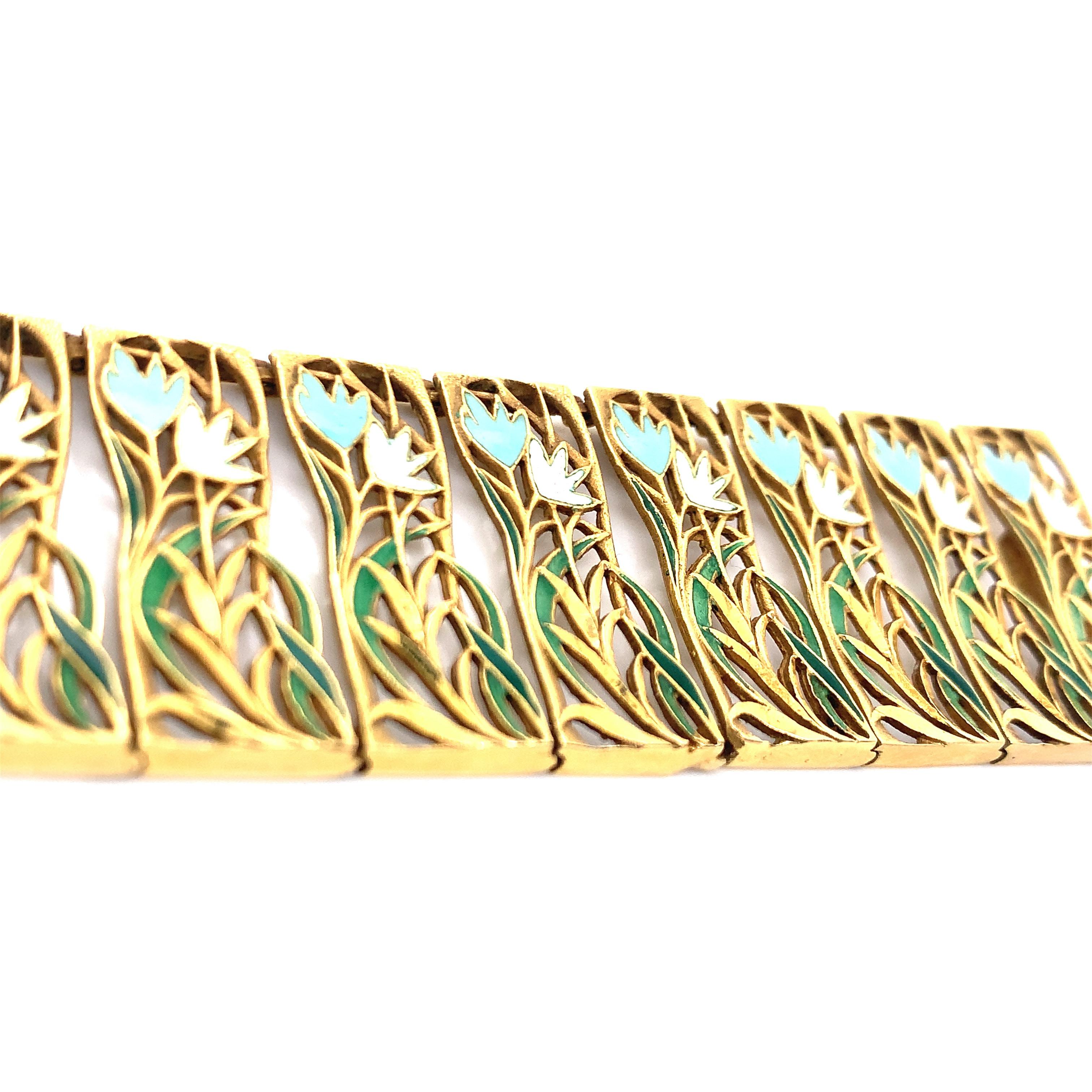 An 18k yellow gold bracelet with an art nouveau design. It features flowers and leaves motifs created through enamel. This flora related piece weighs 49.4 grams with an inner circumference of 7.38 inches. 