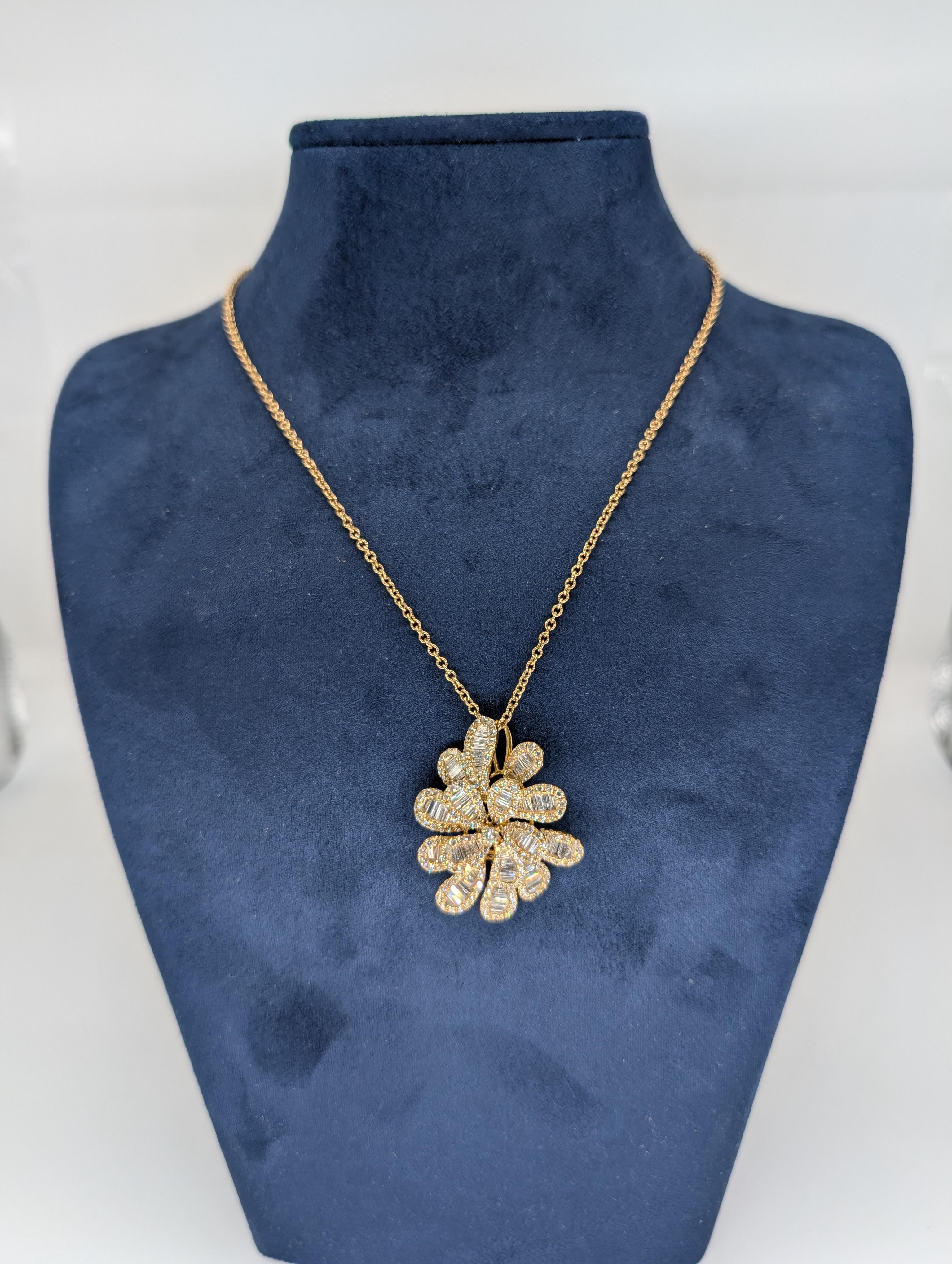 This elegant 18K yellow gold pendant features a beautifully designed blooming flower with delicate petals, adorned with a stunning combination of baguette and round-cut diamonds totaling 3.48 carats. The exquisite diamonds are carefully set to