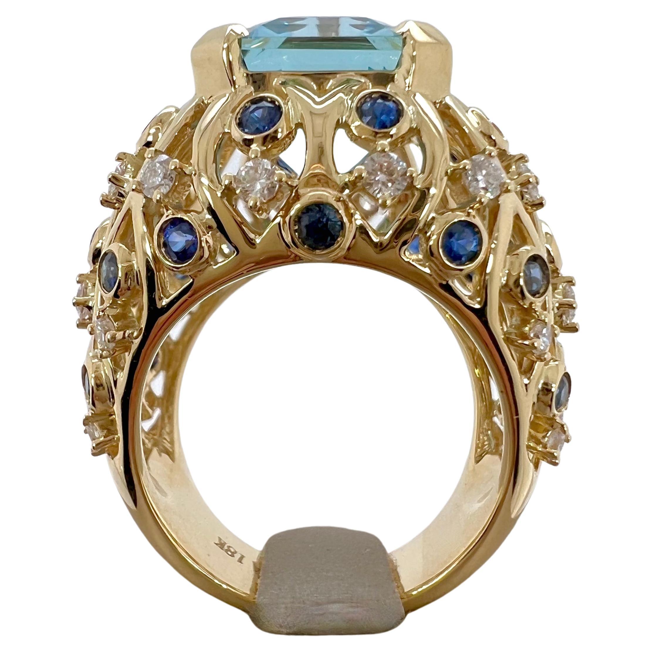 This immaculate aquamarine is set in a handmade setting with blue sapphires and diamonds on 18k yellow gold.  The crips, blue hue of the aquamarine captivates, while the blue sapphires and diamonds complement the stone perfectly.  This ring is a