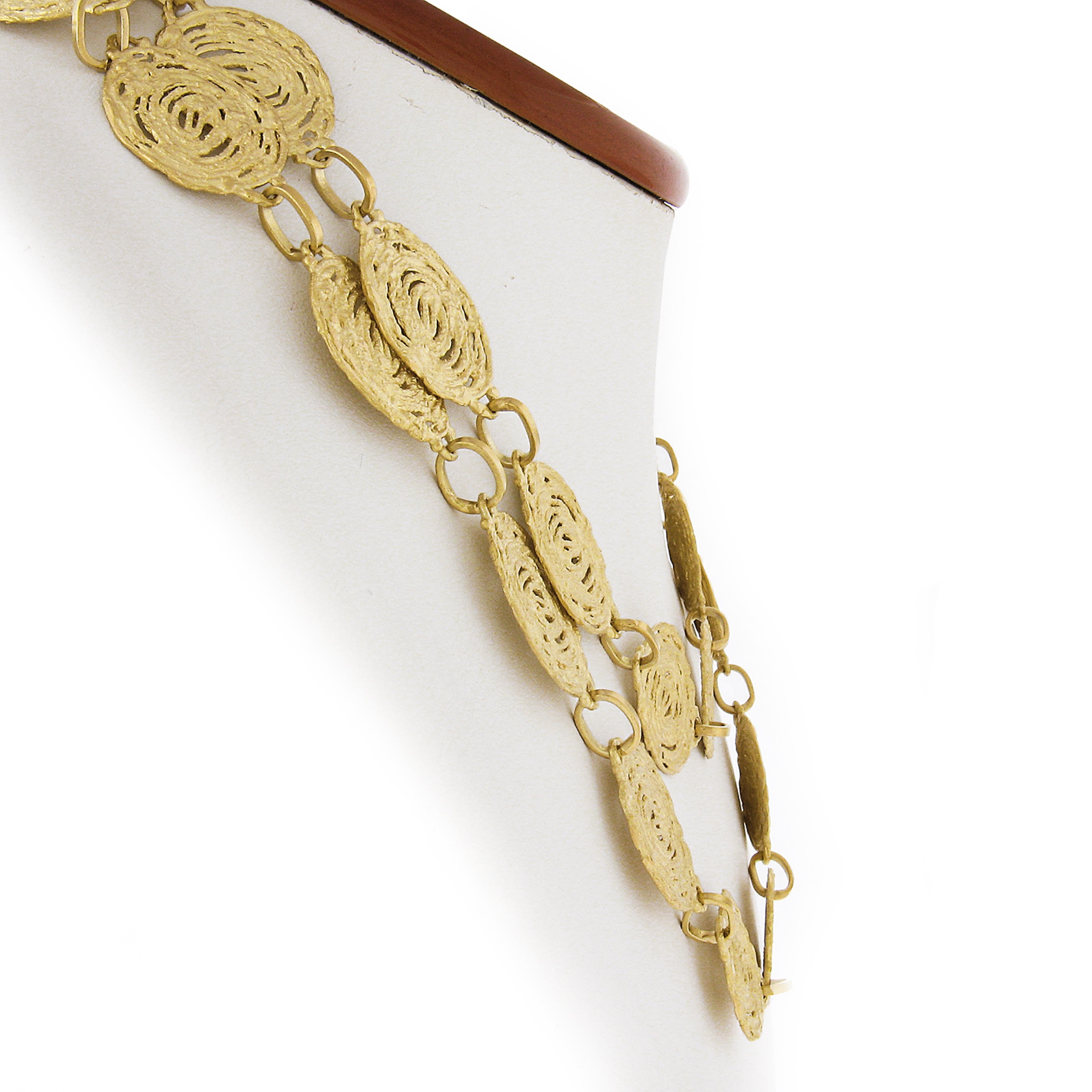 This very unusual long statement chain necklace is very well crafted in Italy in solid 18k yellow gold. Its design features unique free form swirl link design that almost looks like a tree stump print with dual finishes. This chain measures 34