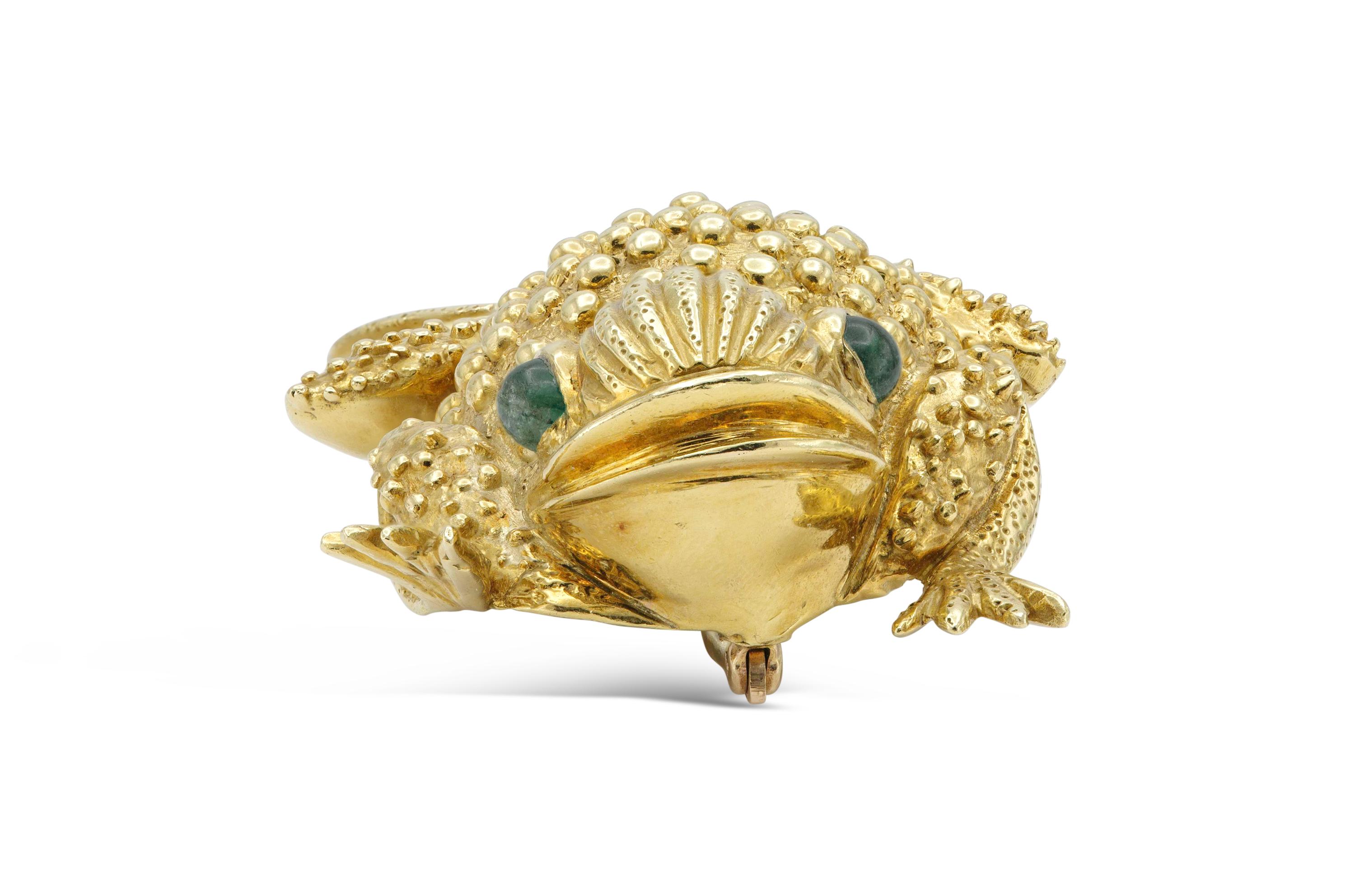 Finely crafted in 18K yellow gold with two cabochon emerald eyes weighing a total of approximately 1.20 carat.
64.30 grams total weight.  