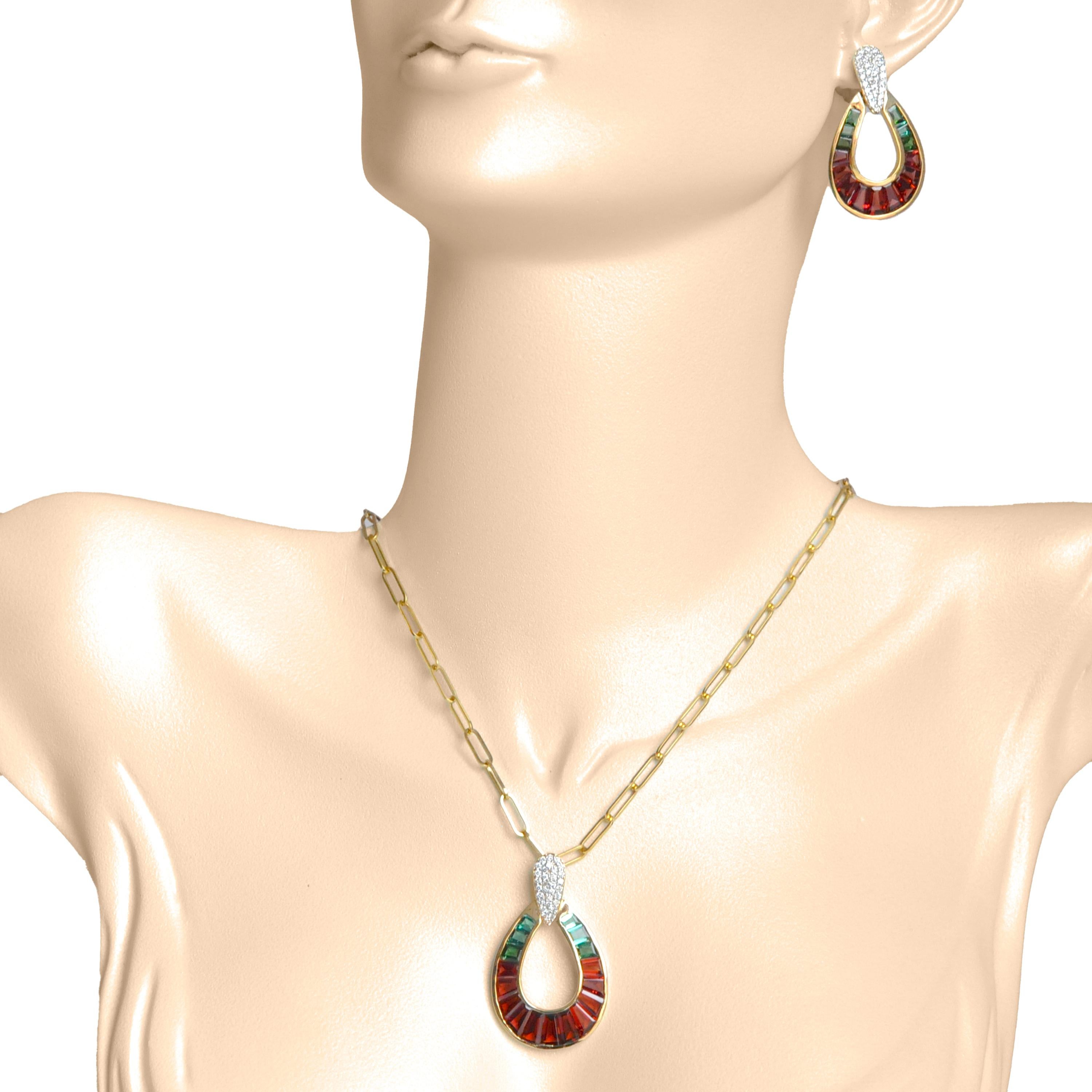 18 karat yellow gold taper baguette garnet and green tourmaline raindrop diamond pendant necklace earrings set.

This one-of-a kind extraordinarily unique pendant earrings set features lustrous garnets and green tourmalines, meticulously picked for