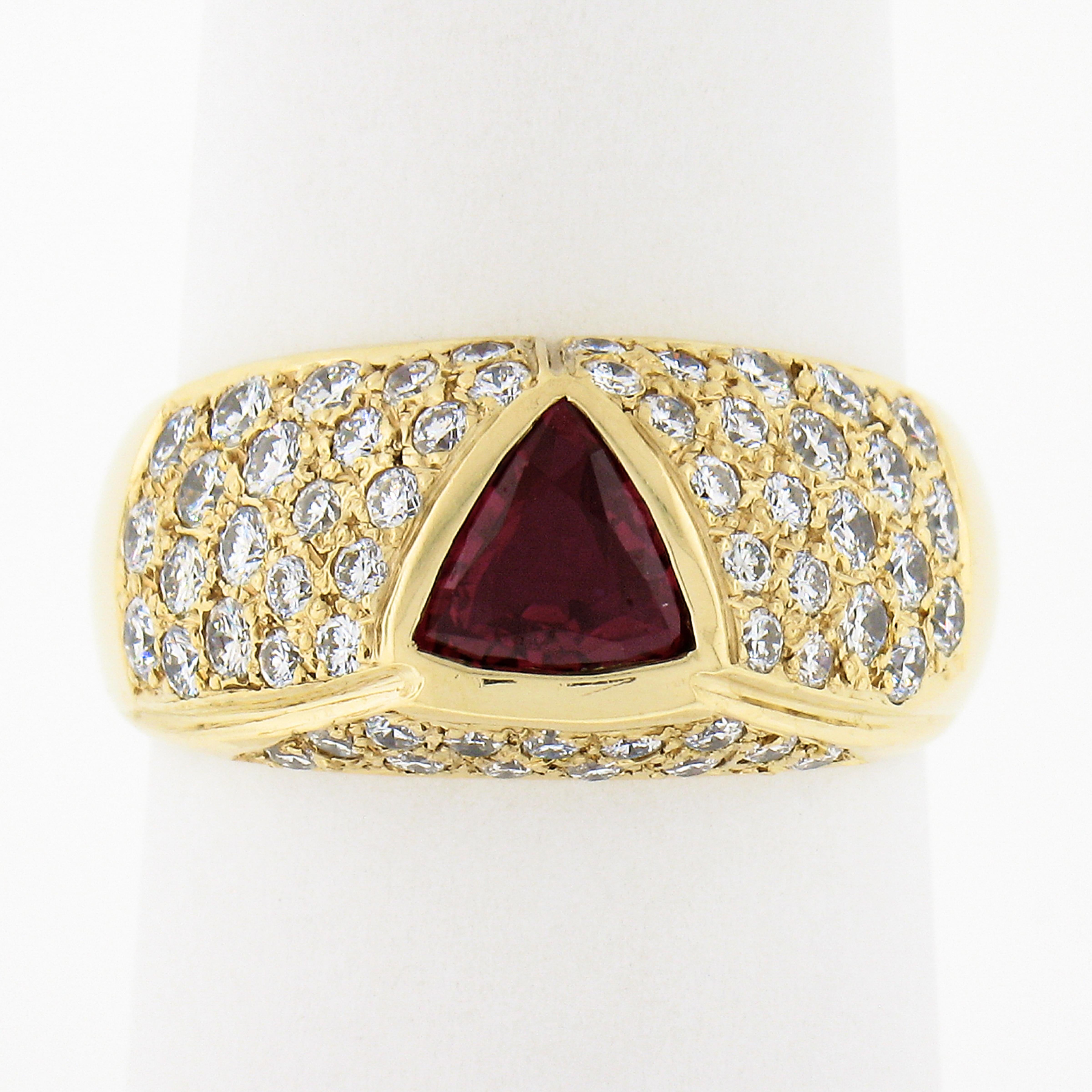 This incredible band ring is crafted in solid 18k yellow gold and features a GIA certified natural ruby neatly bezel set at the center. The ruby has a lovely triangular cut and shows a gorgeous vivid red color with amazing amount of shine due to its
