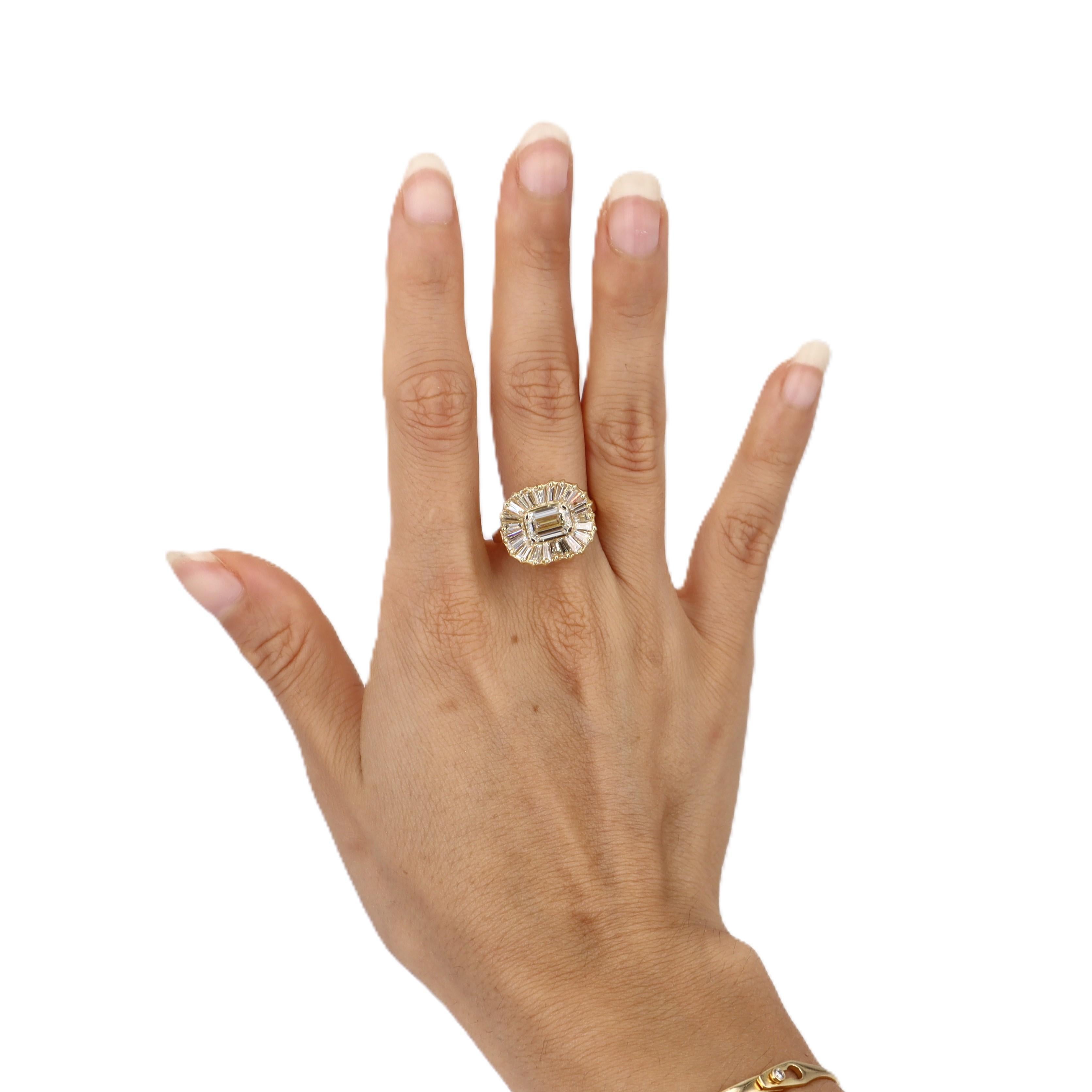 This breathtaking contemporary ring showcases a magnificent GIA certified 1.70-carat emerald-cut diamond as its stunning centerpiece. Crafted in lustrous 18kt yellow gold, this exceptional piece features 22 additional diamonds totaling 3 carats,