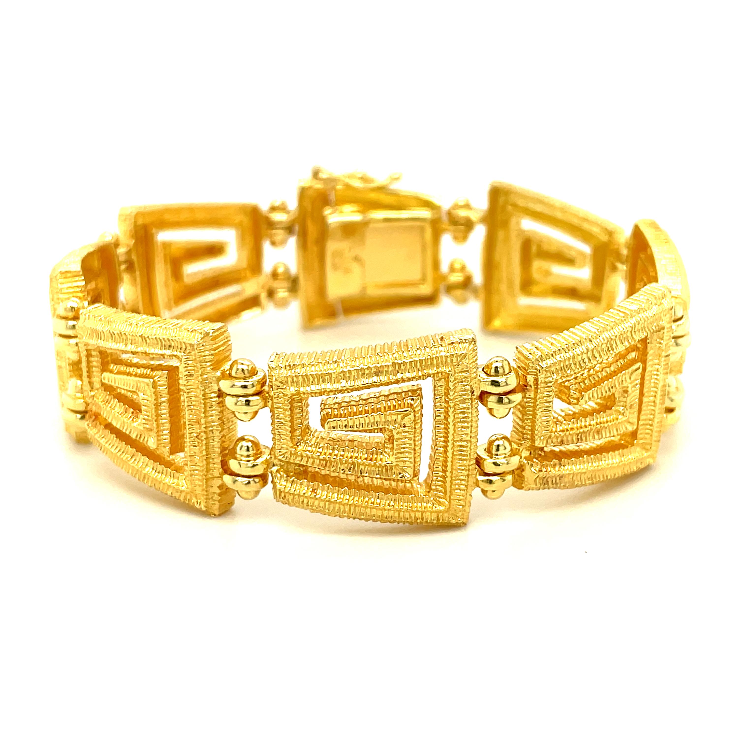 This heavily constructed bracelet features large 18k yellow gold links designed with a repeating Greek key motif. The Greek key design has appeared in civilizations across the globe for centuries, with a geometric appearance that is both artistic