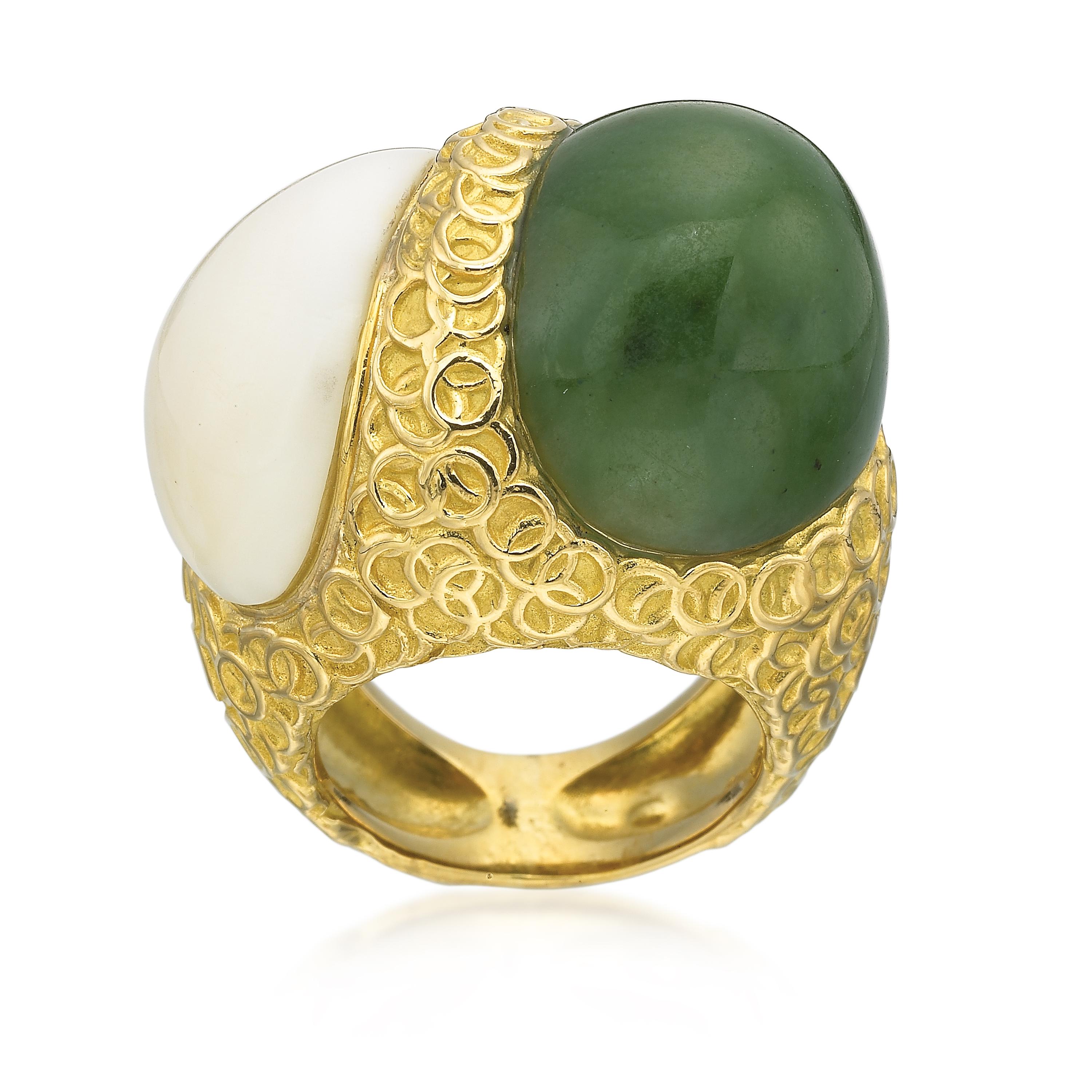 A modern late century (Circa 1980) 40.38 carat Green Nephrite Jade cabochon cut stone pairs nicely along with a 13.98 carat white cabochon cut jade stone. The circular design intertwining the two fabulous stones is 18K yellow gold. Ring comes in