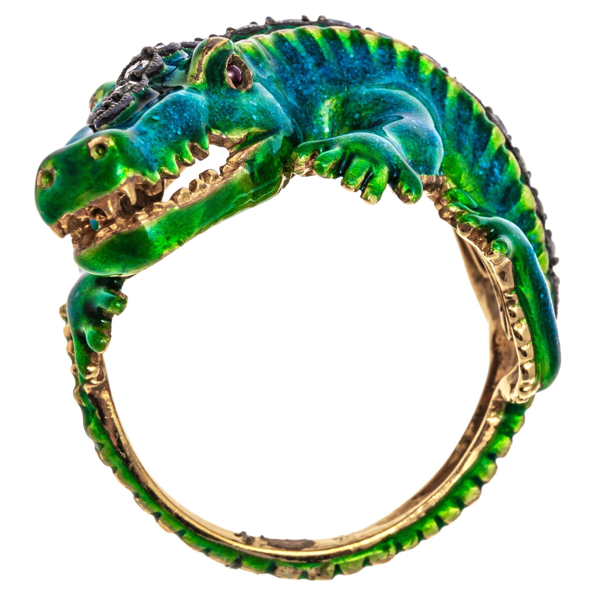 18k yellow gold ring. This stunning ring is a figural alligator, set with a green and greenish blue color field of enamel, and set down the back with graduated round faceted diamonds, prong set, approximately 0.22 TCW. The alligator is also