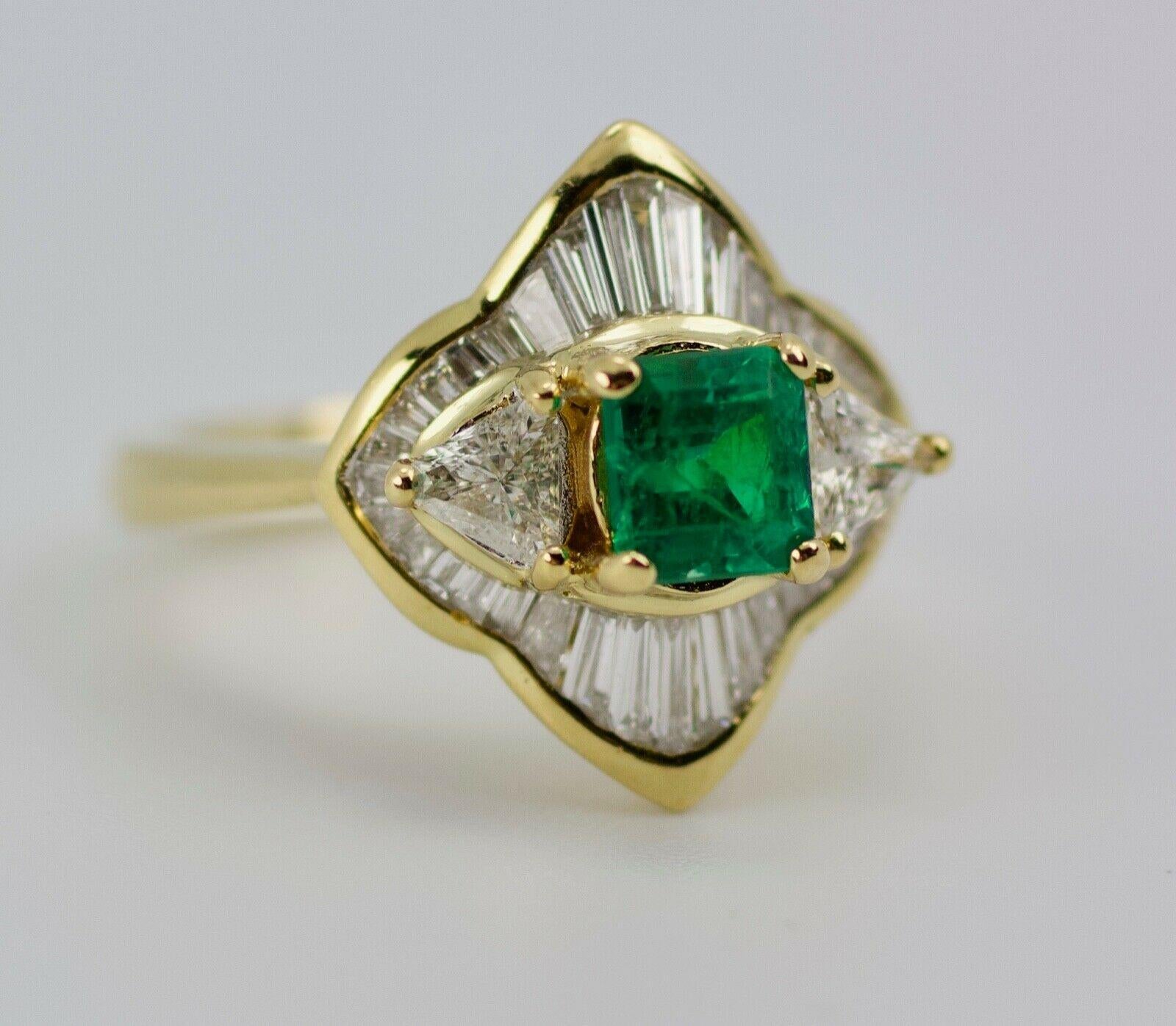 18k Yellow Gold Trillion Cut Diamonds With A Halo Of Baguette Diamonds And An Emerald Cut Green Emerald Ring
6.6 Grams
Ring Size 5.75
Baguette White Diamonds .65 Carats Total Weight
2 Trillion Cut Diamonds 0.60 Carats Total Weight
Clarity: VS1