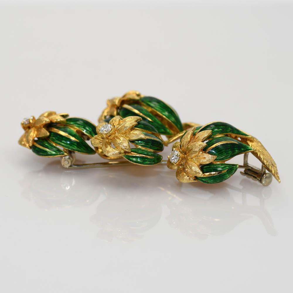 Vintage 18k yellow gold and green enamel brooch with diamonds.
Tests 18k and weighs 18.5 grams.
Flower design with green enamel accents.
There are four round brilliant cut diamonds, .25 total carats, G, H, i color range, Vs to Si clarity.
The brooch