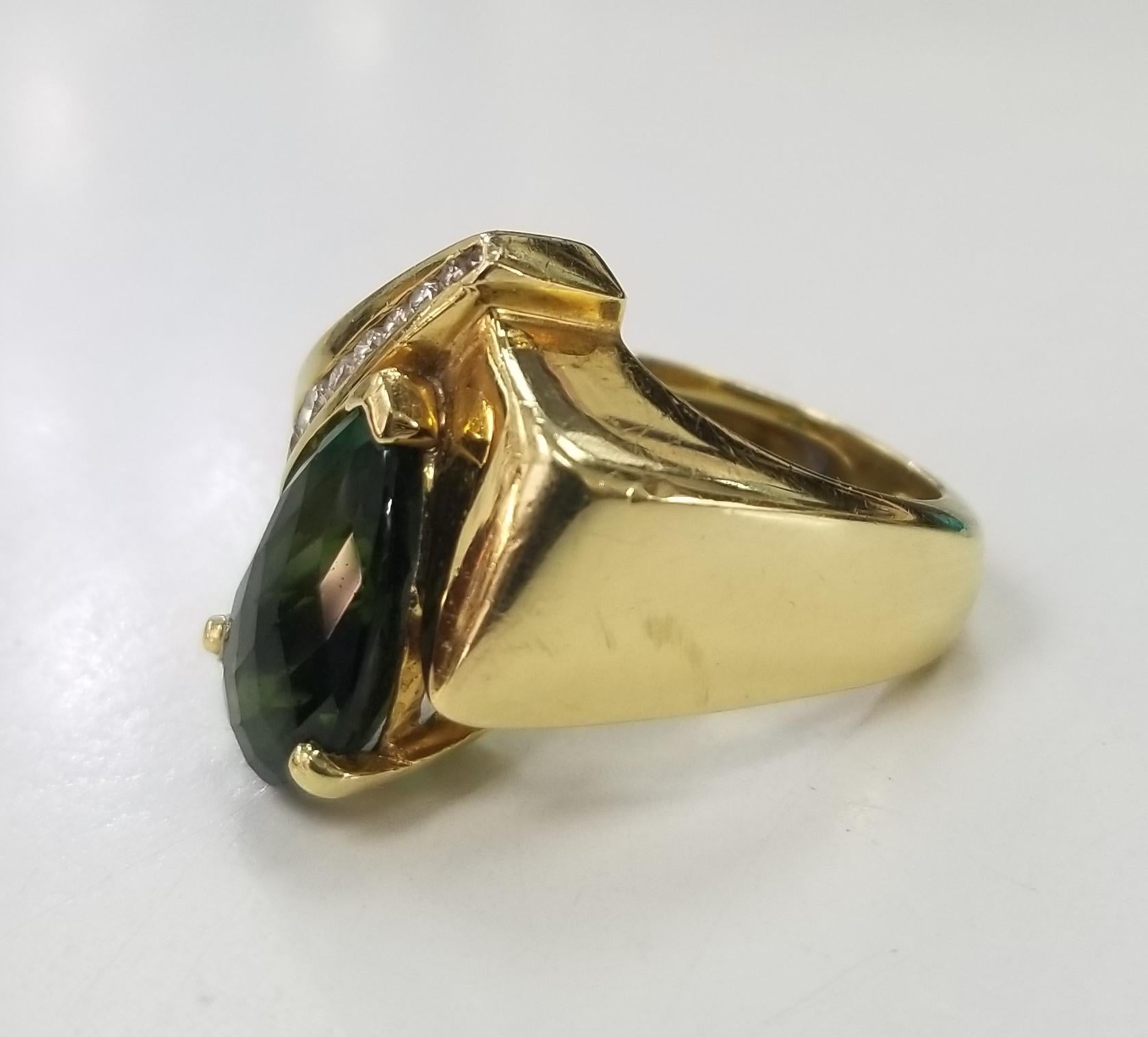 18k yellow gold green tourmaline and diamond ring,
Specifications:
    main stone: Checker board cut Pear shape Green Tourmaline 4.78cts.
    diamonds: 8 PIECES
    carat total weight: APPROX .30 CTW
    color: G
    clarity: VS1
    metal: 18K