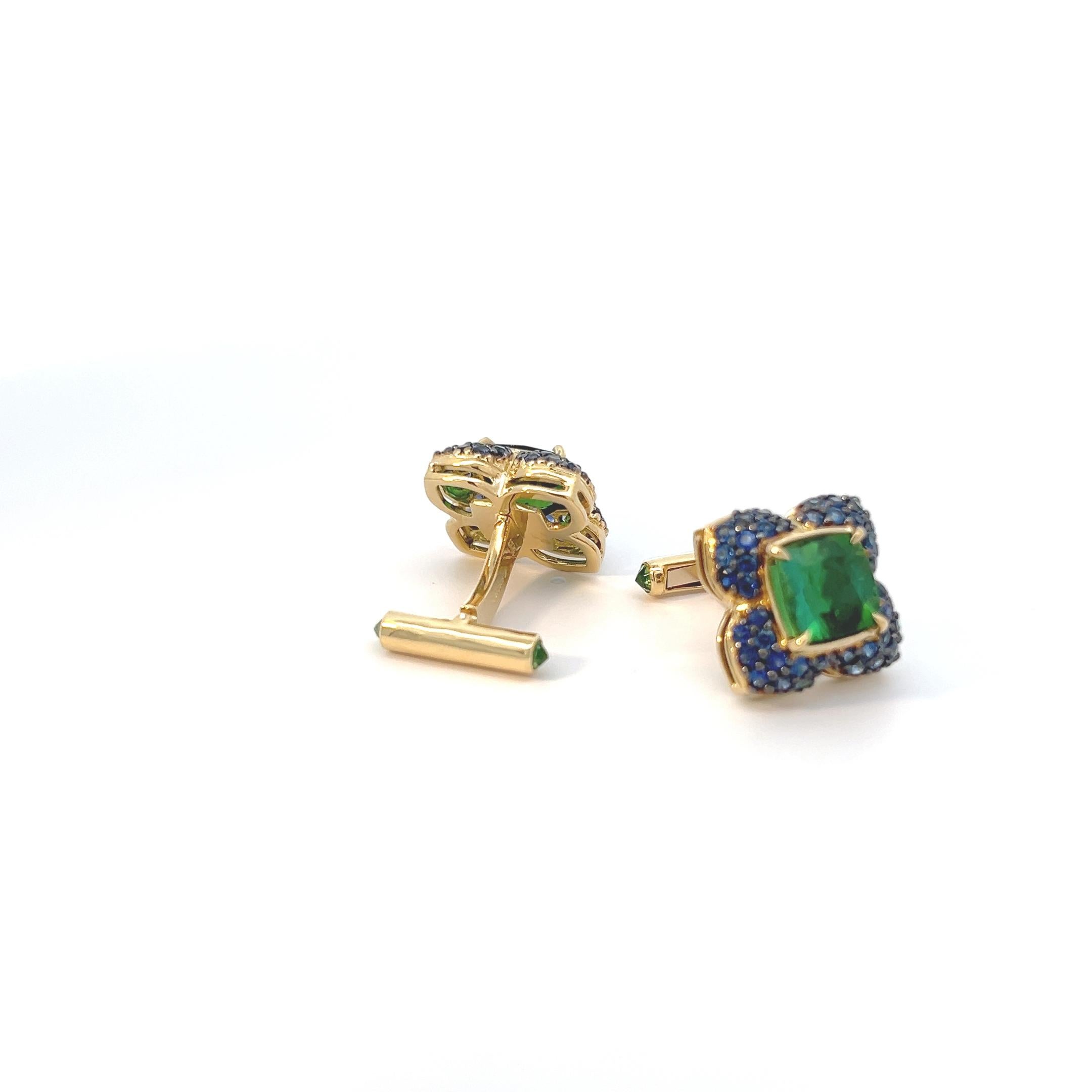 Introducing a stunning pair of cufflinks crafted in lustrous 18k yellow gold. At the heart of each cufflink gleams a captivating array of exquisite green tourmalines, totaling approximately 9 carats. These verdant gemstones command attention, each
