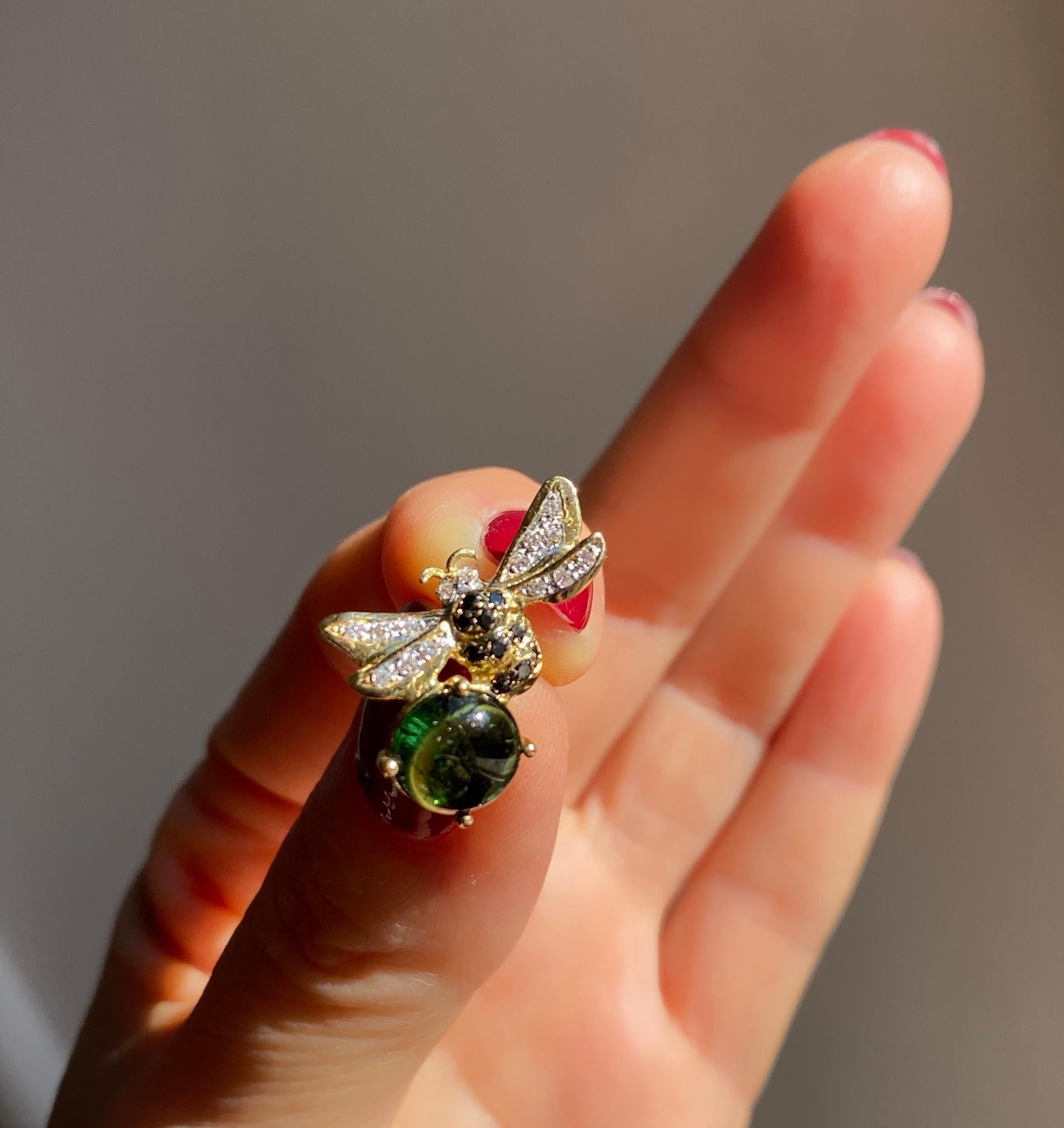 Rossella Ugolini bee pin brooch  handcrafted in 18k yellow gold white diamonds, black diamonds and round Cabochon cut Green Tourmaline .  
Dimensions: 0.79 in. (2 cm) x 0.79 in. (2 cm).
These 18K Yellow Gold Pin Brooch, adorned with ct. 0,10 white