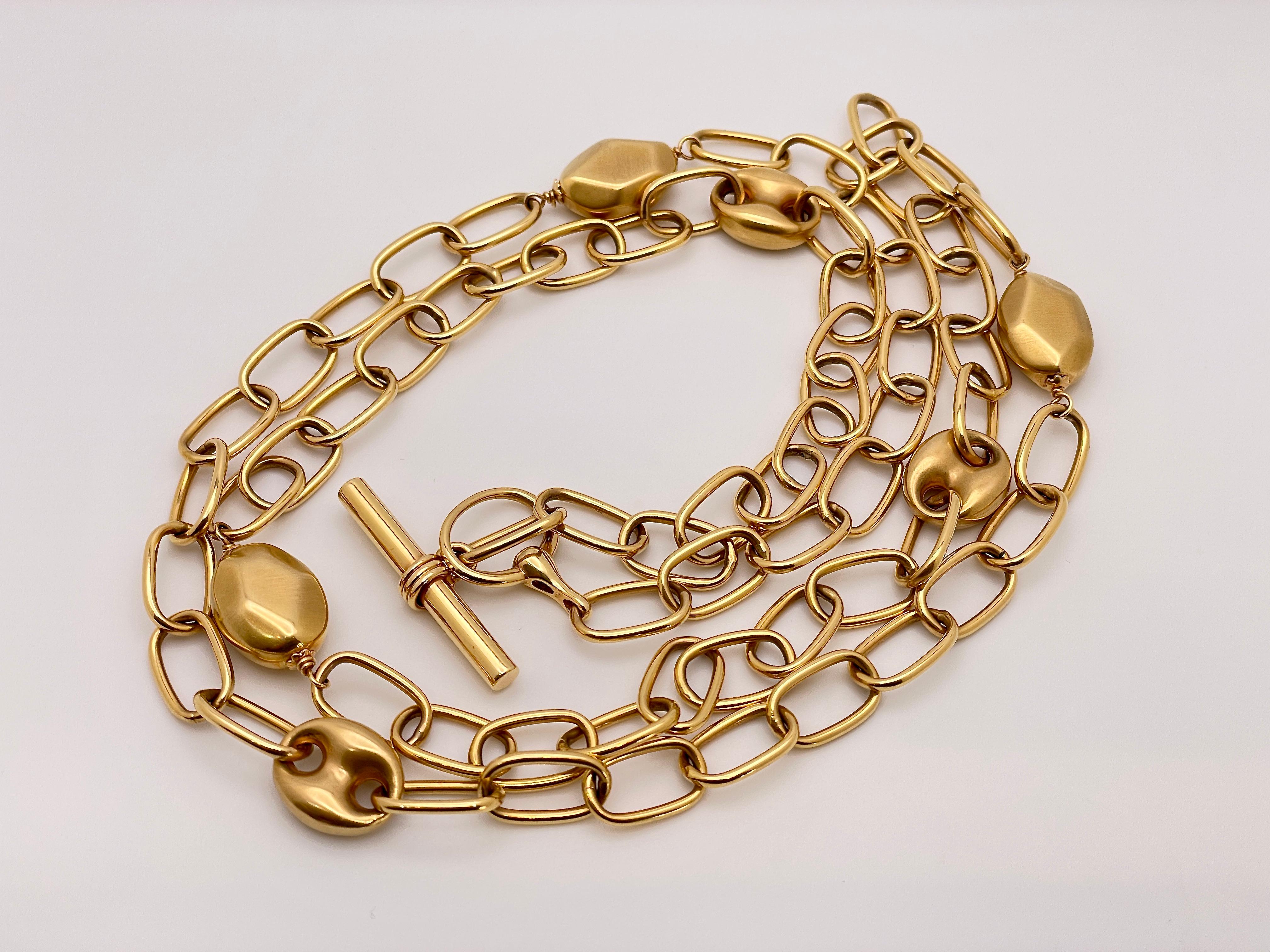 A magnificent 18K rose gold handmade toggle clasp link necklace, featuring a Gucci design. The necklace is decorated with multifaceted gold beans and Gucci designed links. This elegant necklace measures 35 inches, and has a gross weight of 51 grams. 