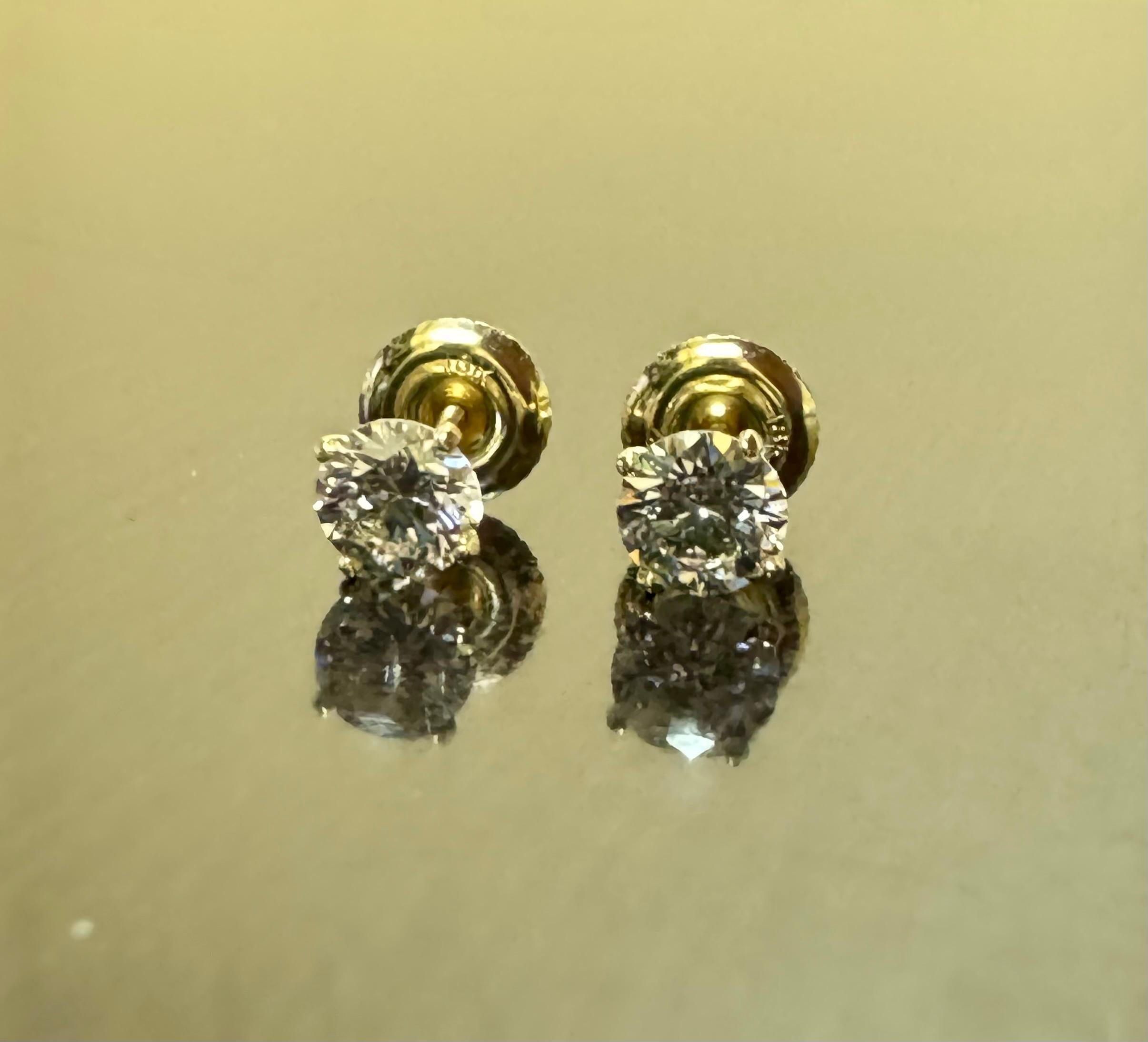 DeKara Designs Classic

Metal- 18K Yellow Gold, .750.

Stones- 2 GIA Certified Round Diamonds, 1 H Color VS1 Clarity 0.54 Carats, 1 H Color VS1 Clarity 0.53 Carats. Both Diamonds are Laser Insribed.

Earrings Come With GIA Diamond Dossiers
0.57 H
