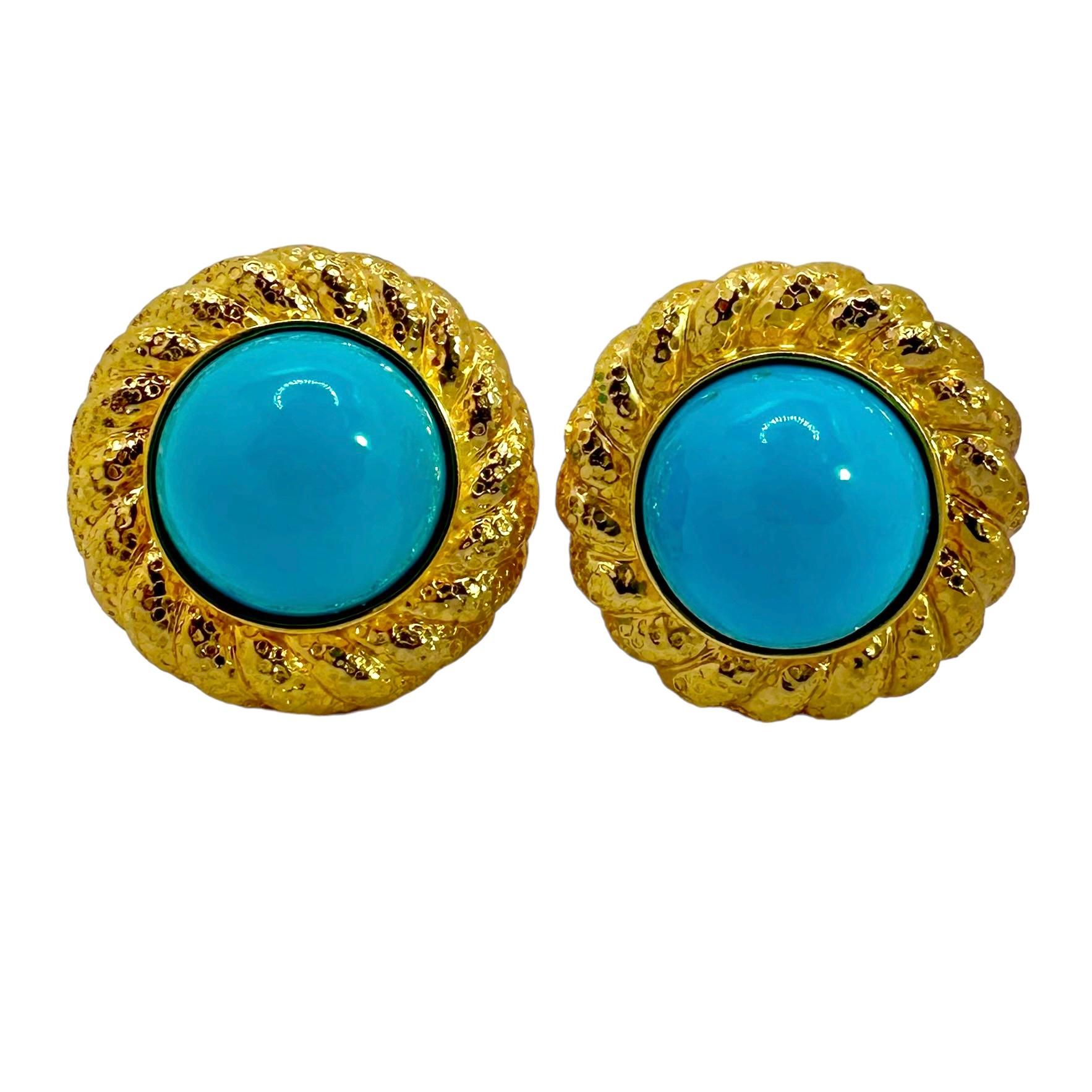 This very distinctive pair of 18k yellow gold casual earrings have at their center composite turquoise* cabochons, each measuring 15mm in diameter and approximately 9mm in height at their apex. Surrounding these vibrant centers is a border of
