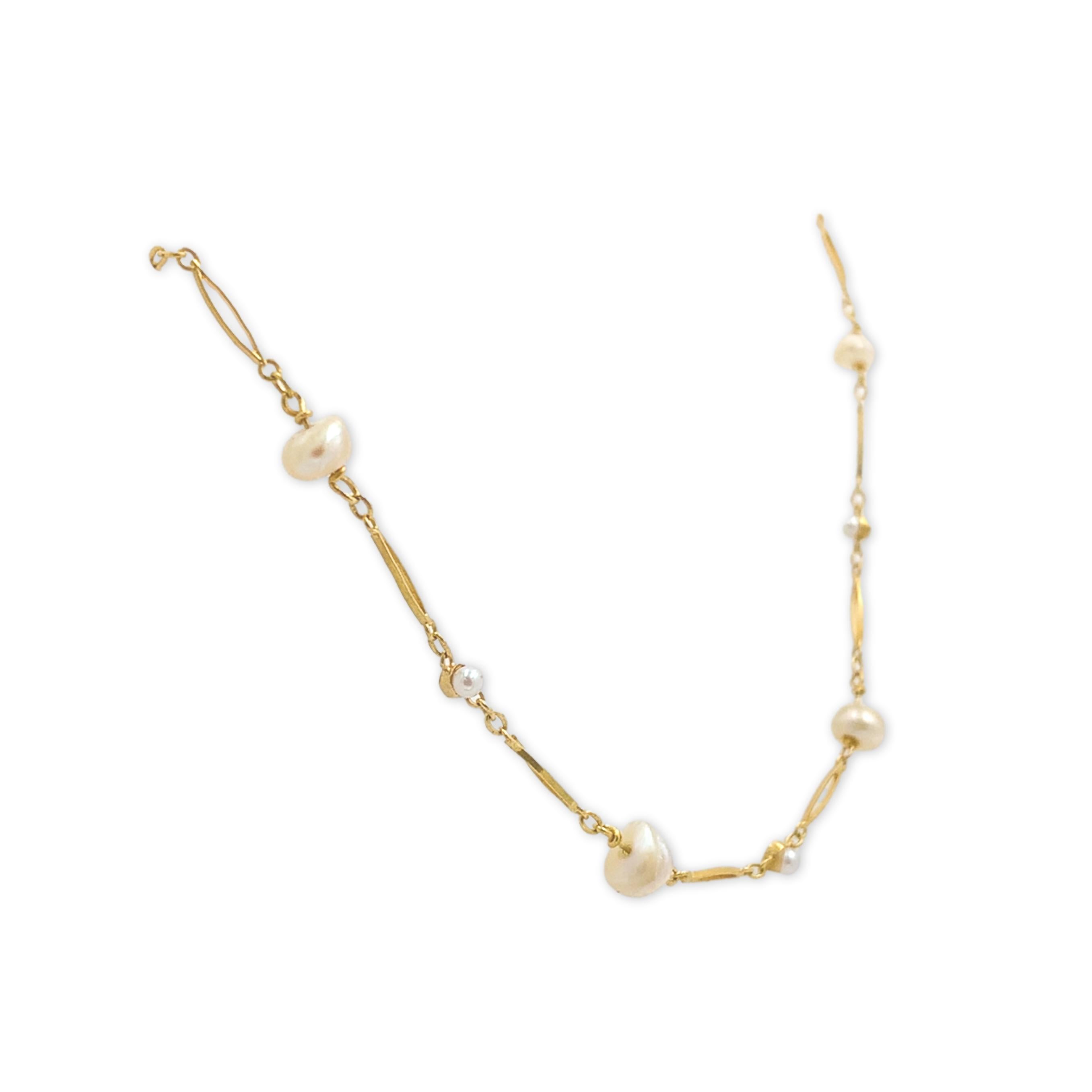 Antique 18K yellow gold chain necklace featuring freshwater river pearls. The hand made links are long ovals alternating with 10 baroque freshwater pearls measuring about 4.5mm - 5.5mm. There are also 14 tiny full drilled pearls measuring about