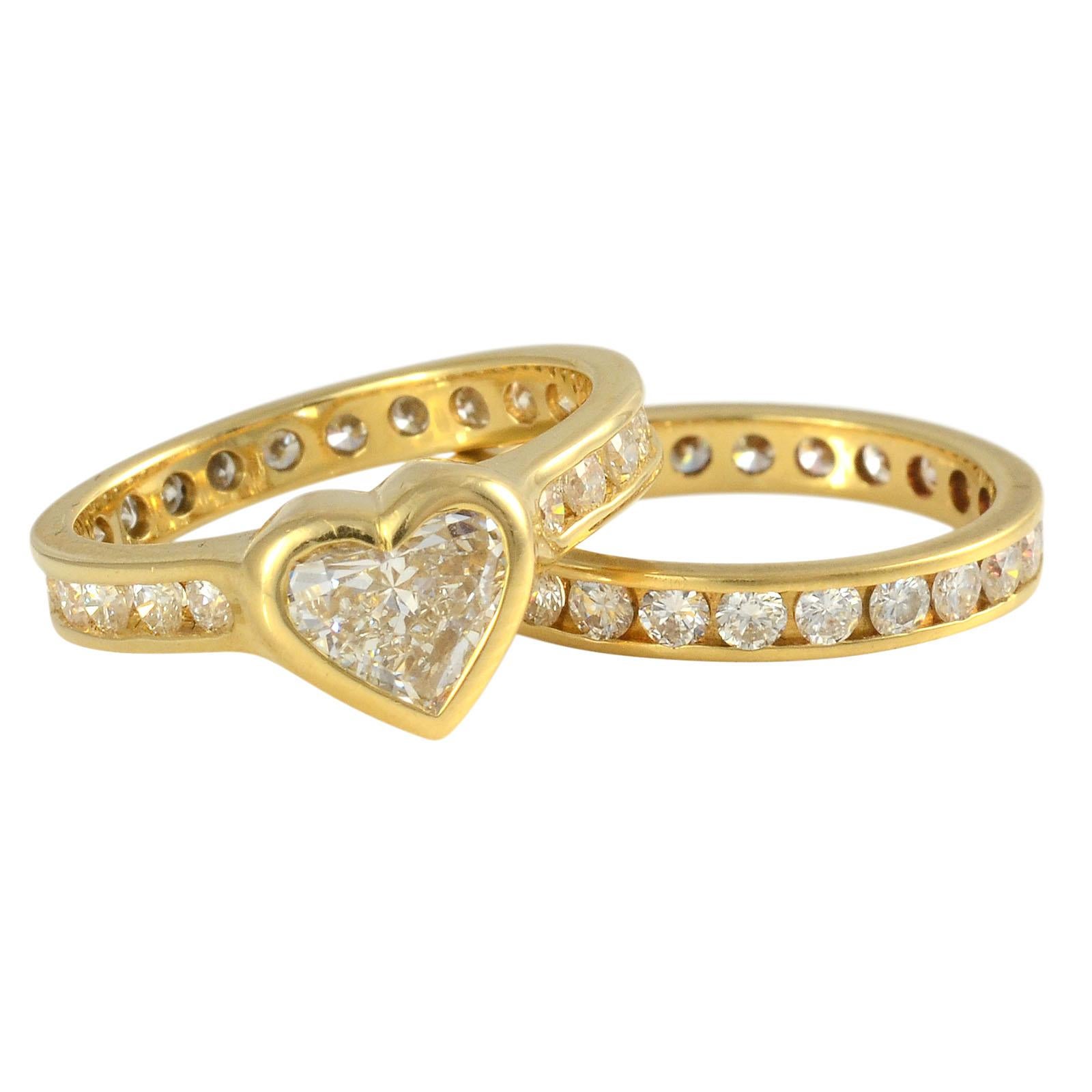 Estate 18K yellow gold heart diamond wedding set. The estate wedding set features a 0.72 carat heart diamond with VS1 clarity and F color. This heart diamond engagement ring also has 22 channel set diamonds at 0.82 carat total weight with VS1-2