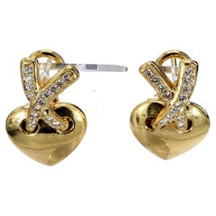 Pendientes en forma de corazón de oro amarillo de 18k con detalles de diamantes