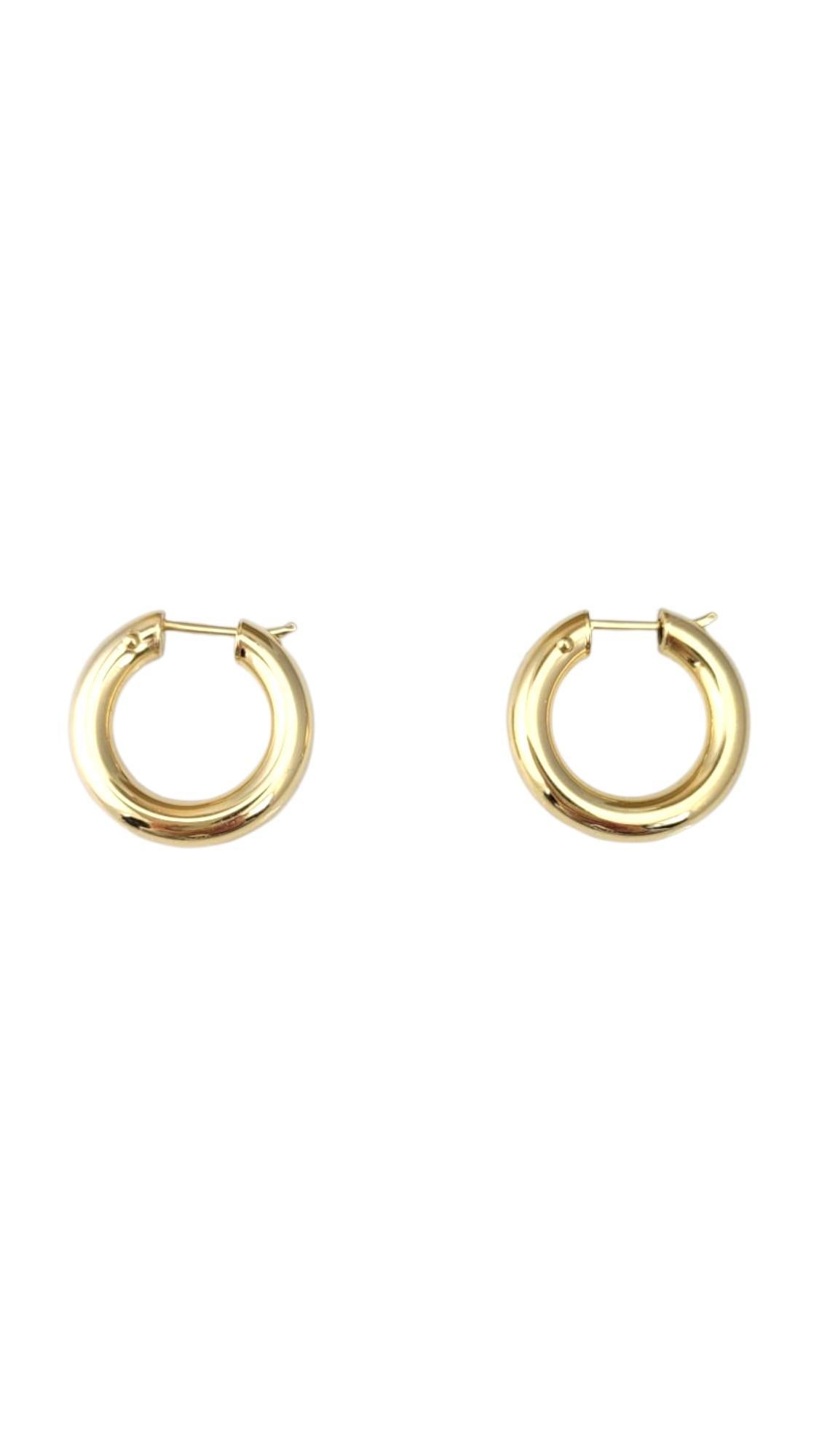 18K Yellow Gold Hoop Earrings -

These hoop earrings feature a timeless, versatile design that complements any style. With their sleek silhouette and polished finish, they add a touch of effortless elegance—perfect for everyday wear or dressing up