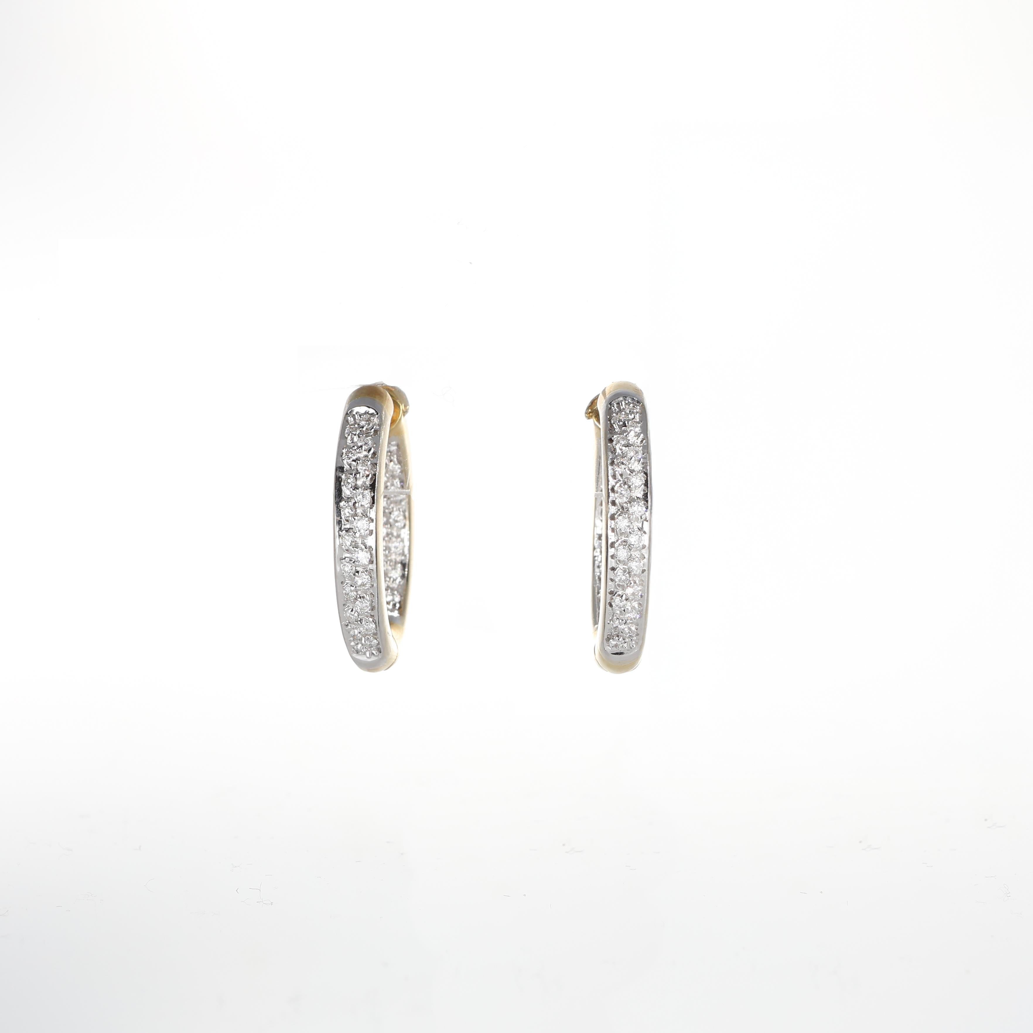 A stunning pair of hoop earrings crafted in 18K yellow gold, featuring an elegant inside-out diamond pavé design. Brilliant-cut diamonds totaling 0.88 carats adorn both the exterior and interior of the hoops, offering an unparalleled sparkle from