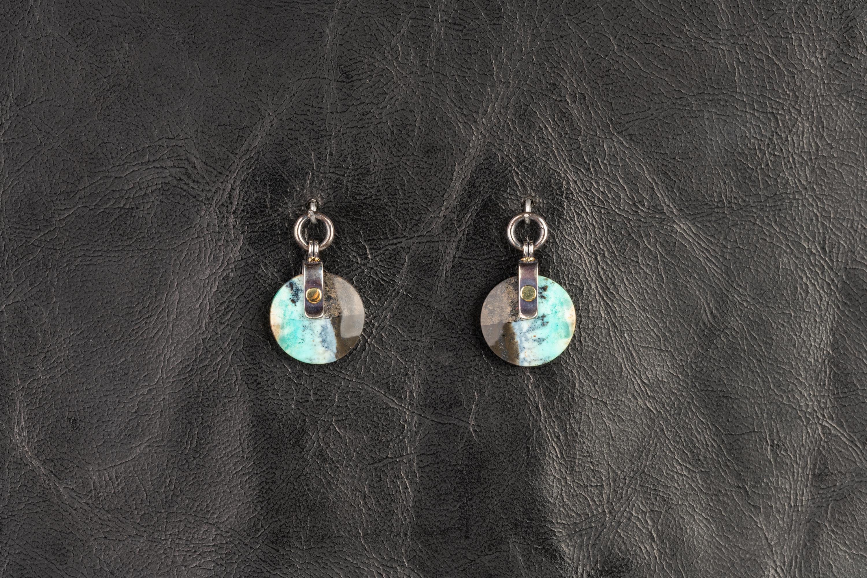 A pair of 18k yellow gold textured swoop hoops with a pair oxidized sterling silver and 18k yellow gold jackets riveted with two 14.5mm round opal and petrified wood slices. These earrings were made and designed by llyn strong.
Items can be priced