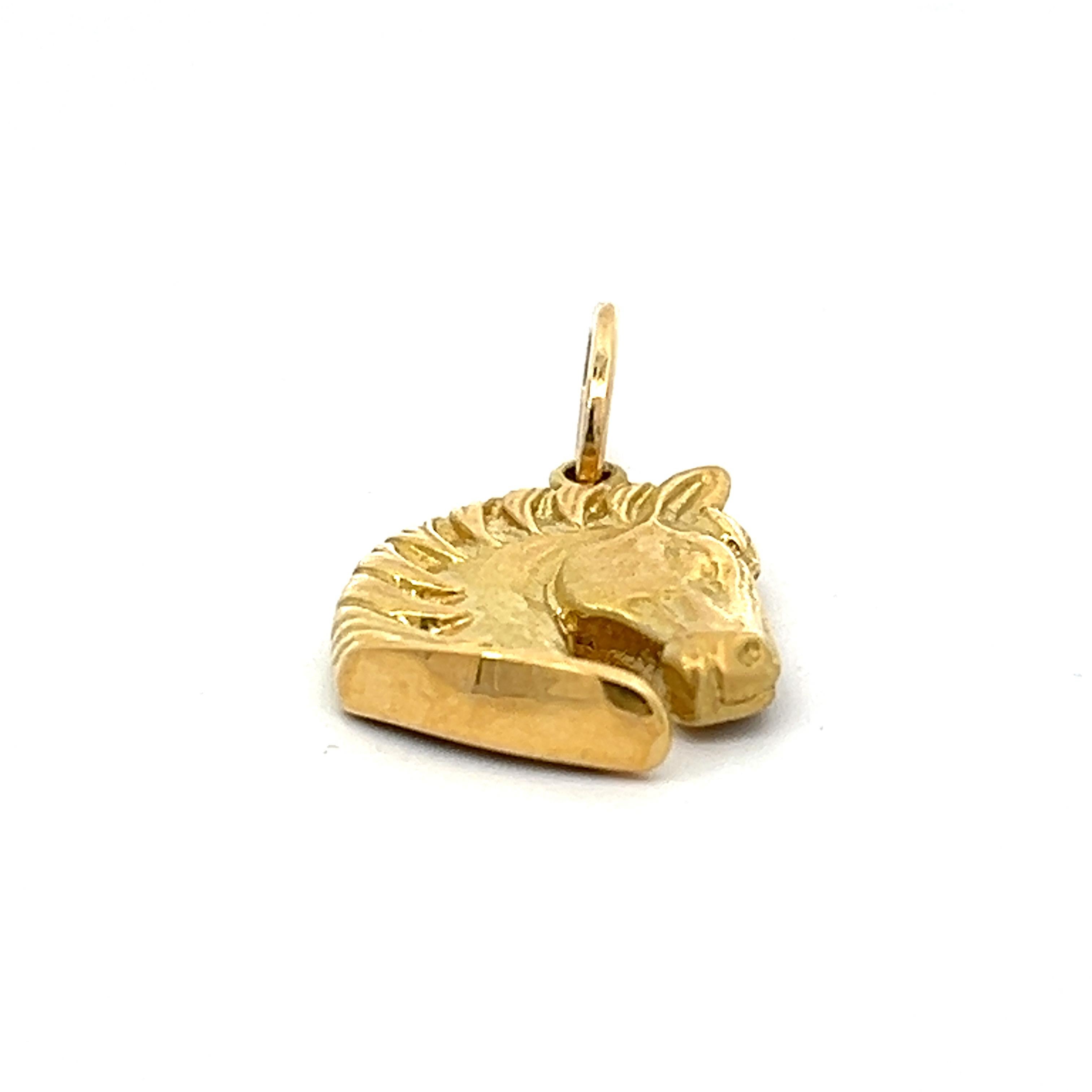Equestrian elegance meets exquisite craftsmanship in our 18k Yellow Gold Horse Pendant—a radiant embodiment of grace and strength. This finely detailed pendant captures the majestic spirit of a horse in a compact 19 x 16mm size, not including the
