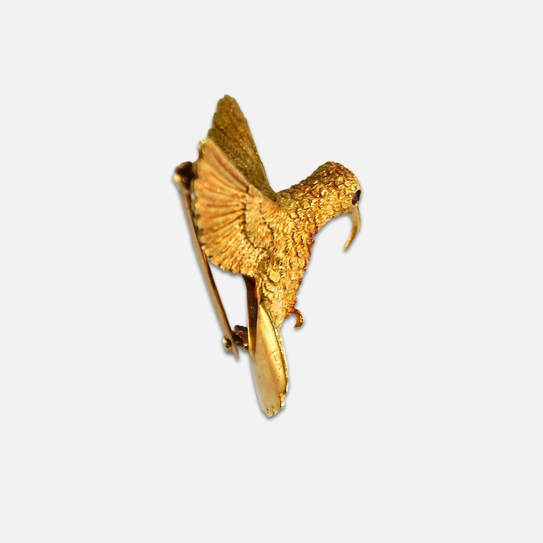 18k yellow gold humming bird brooch.
Tests 75% gold with an XRF analyzer and weighs 12.4 grams.
The brooch measures 1 1/2 inches wide and 1 inch tall.
Very good condition.