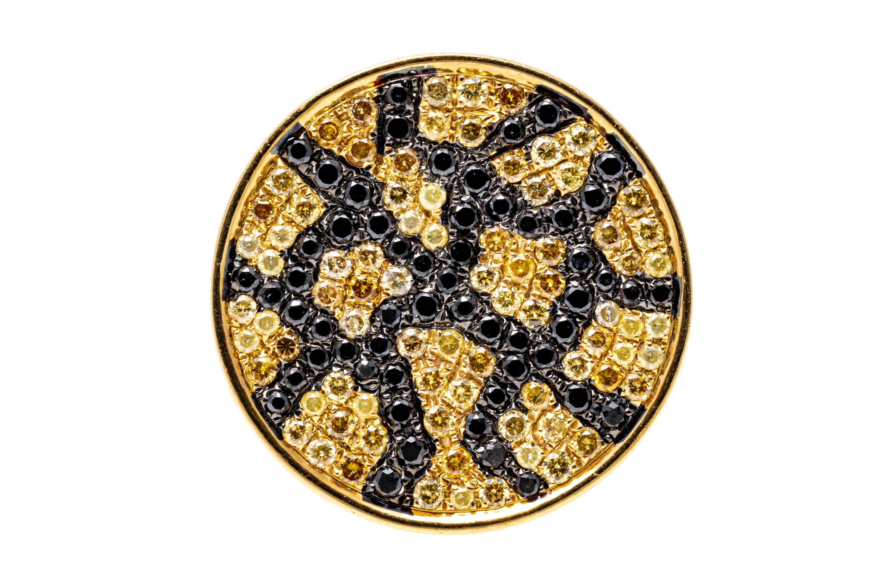 18k yellow gold ring. This stunning ring is a round, pave diamond set top, set with a field of pale and dark yellow diamonds, punctuated with round black faceted diamonds to give a leopard print pattern. The diamond weight for the ring is 1.13