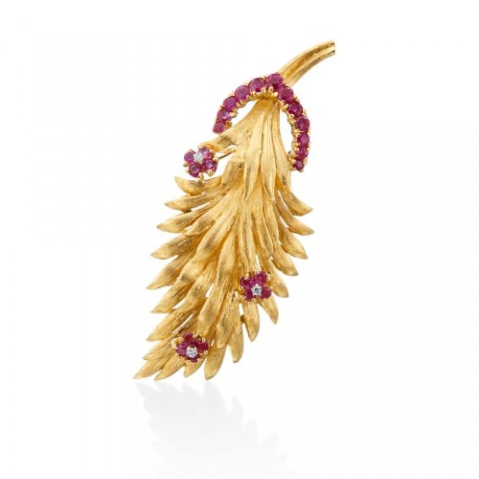 Bring back the retro look with this 1950's, 18K yellow gold leaf brooch with ruby accent flowers and a diamonds. This beautiful antique brooch has a trail of rubies (1.50 ctw) and single cut diamonds (.01 ctw with G Color and VS1 clarity). 