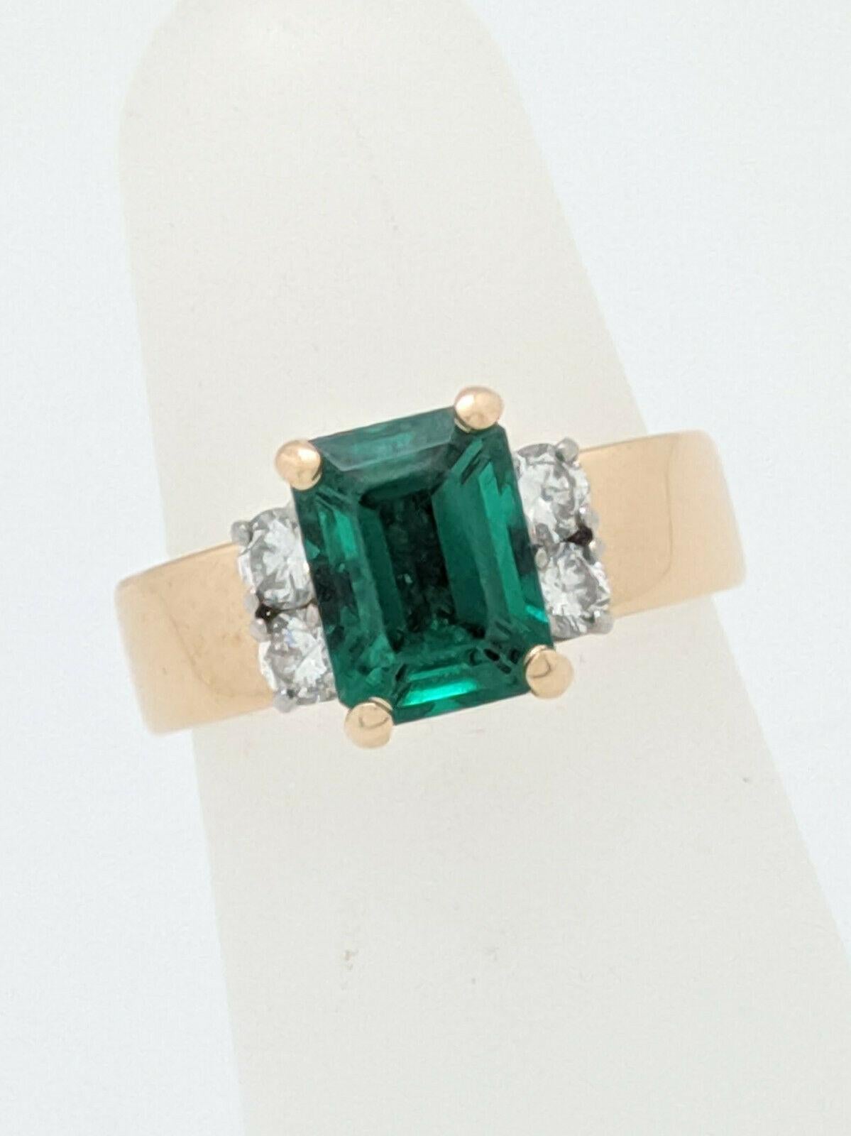 You are viewing a beautiful Emerald & Diamond ring made by Jabel. This ring is crafted from 18k yellow gold and weighs 6 grams. It features (1) Emerald Cut Chatham Emeralds that is prong set and measures approximately 8 x 6mm. On each side of the