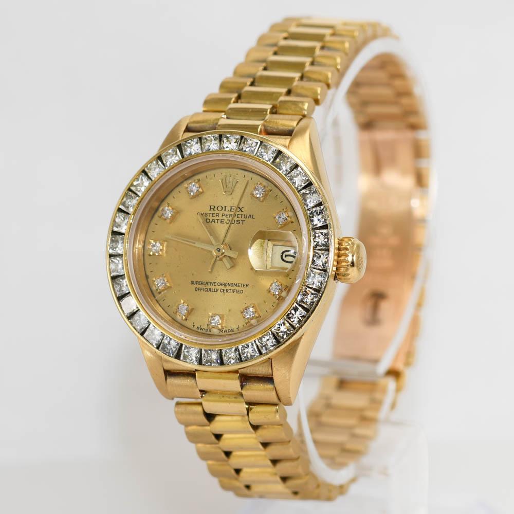 18k Yellow Gold ladies Rolex Datejust with factory Diamond dial.

26MM case size.

The Diamond bezel is aftermarket, 1.70tdw of Princess Cut Diamonds. Clarity SI-VS, Color J-K-L.

Moderate stretch in the band as most older jubilee bands have.

Will
