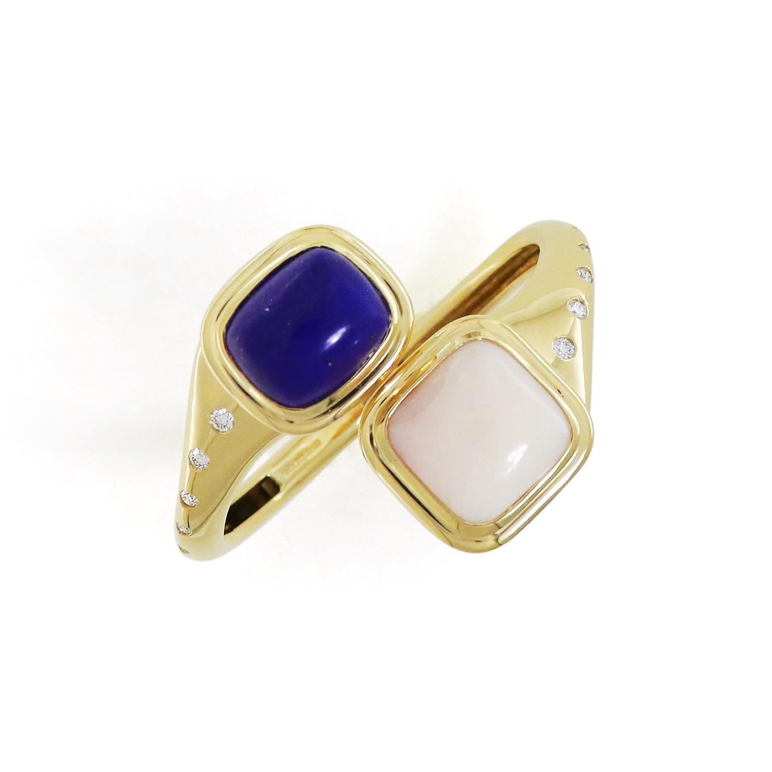 The deep blue lapis lazuli has the ethereal accompaniment of white coral for this 18k yellow gold bangle bracelet. A cushion lapis lazuli in a bezel set on one end with the precious metal accentuates the golden flecks natural to the gemstone. On the