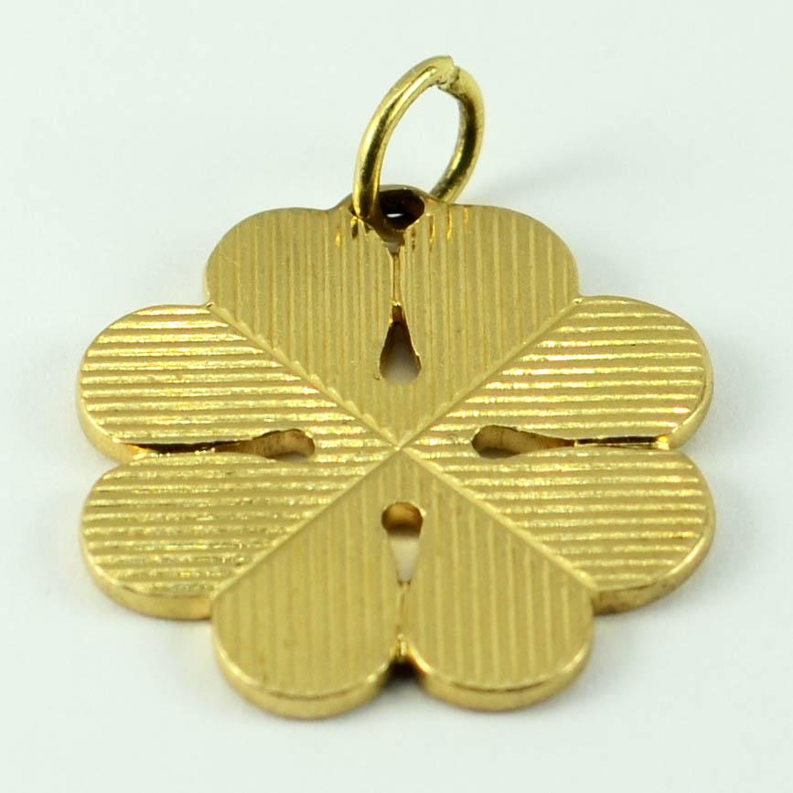 An 18 karat (18K) yellow gold charm pendant designed as a large four-leaved clover or shamrock with engraved lines. Unmarked but tested as 18 karat gold.

Dimensions: 2.8 x 2.3 x 0.2 cm 
Weight: 7.61 grams