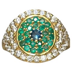 Large Eye Ring with Diamonds and Emeralds in Gold in stock