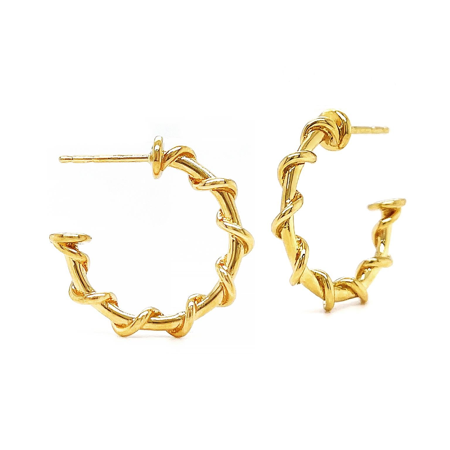A nautical aura creates these timeless hoop earrings. Brilliant 18k yellow gold forms a half-open hoop. A strand of the same metal coils along the hoop as the rope. The half-open hoop features a smooth circle base to give ease when worn. Friction