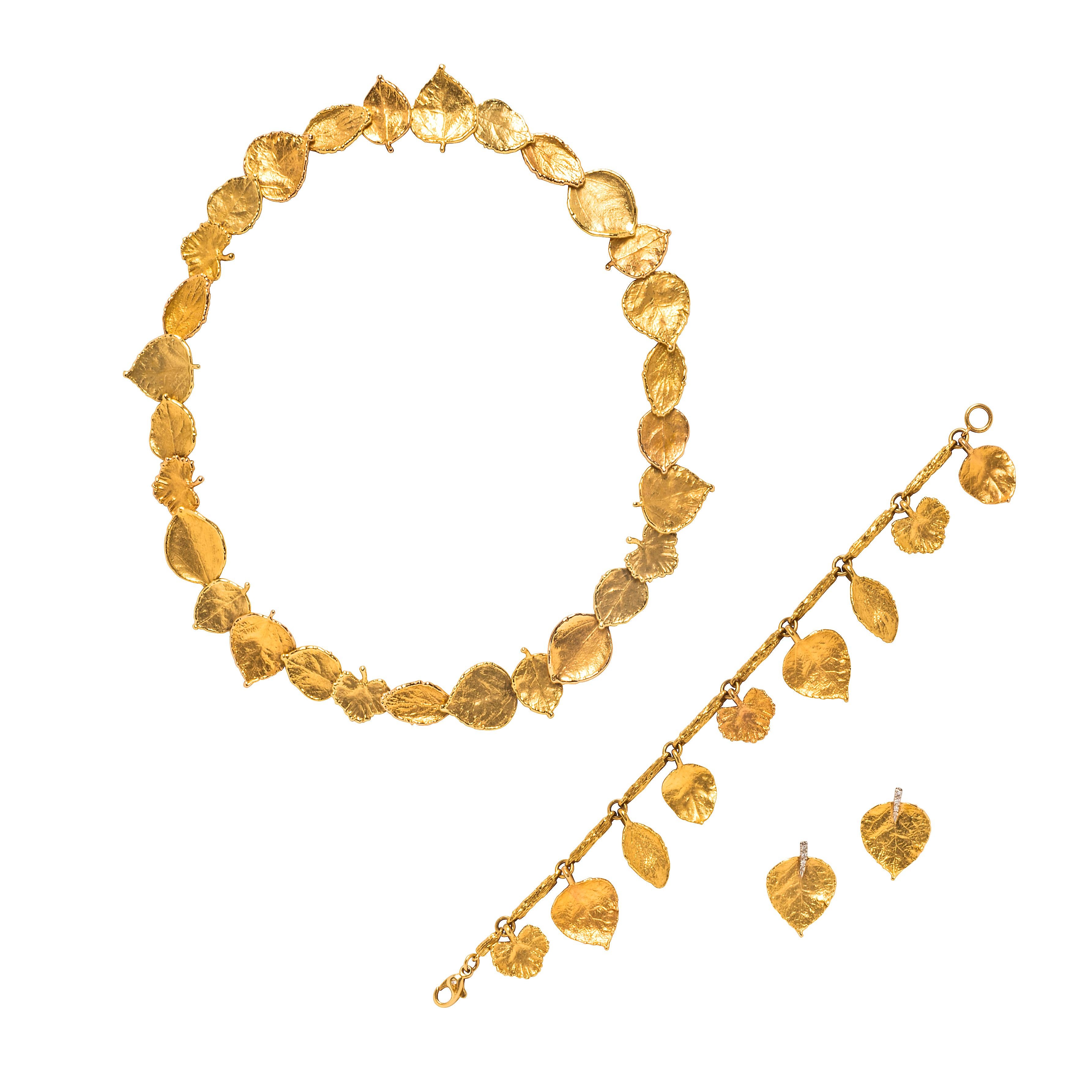 Comprising a necklace set with a series of links in the form of 19k and 18k yellow gold leaves of varying shapes, with ‘AH’ maker’s mark; and a pair of earrings of similar design, with diamond-set stems, set in 18k yellow gold and platinum, signed