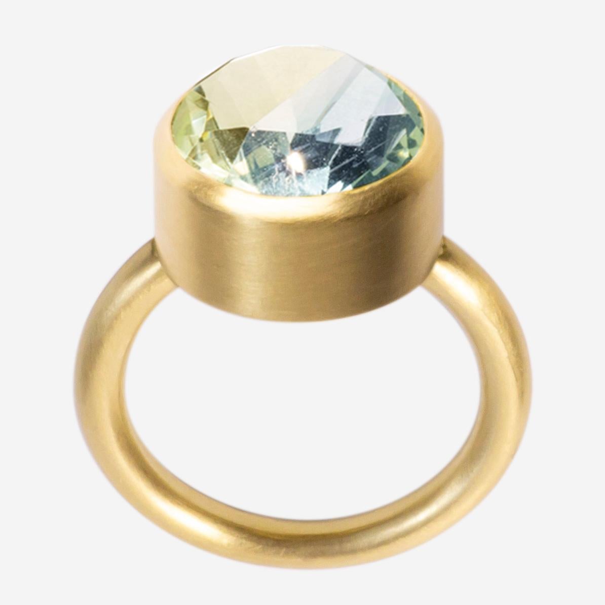 This bold and minimal statement ring is a modern take on the cocktail ring. It features a stone that is fashioned from two natural colored stones that have been fused together then cut and polished as one. When the two characteristics of the