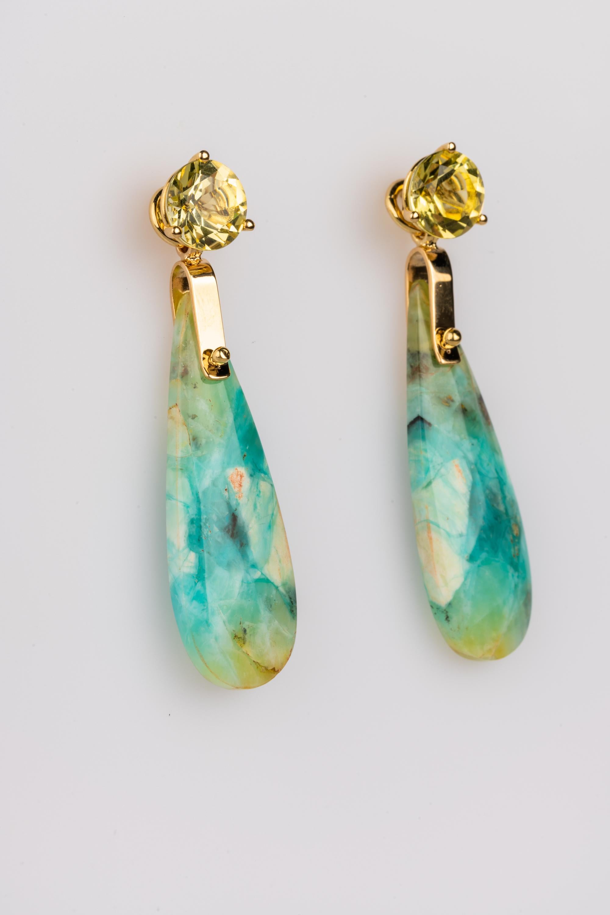 A pair of 18k yellow gold studs set with 8mm lemon quartz and a pair of 34mm x 11mm tear-drop opal and petrified wood jackets in 18k yellow gold. These earrings were made and designed by llyn strong.
Items can be priced separately upon request.