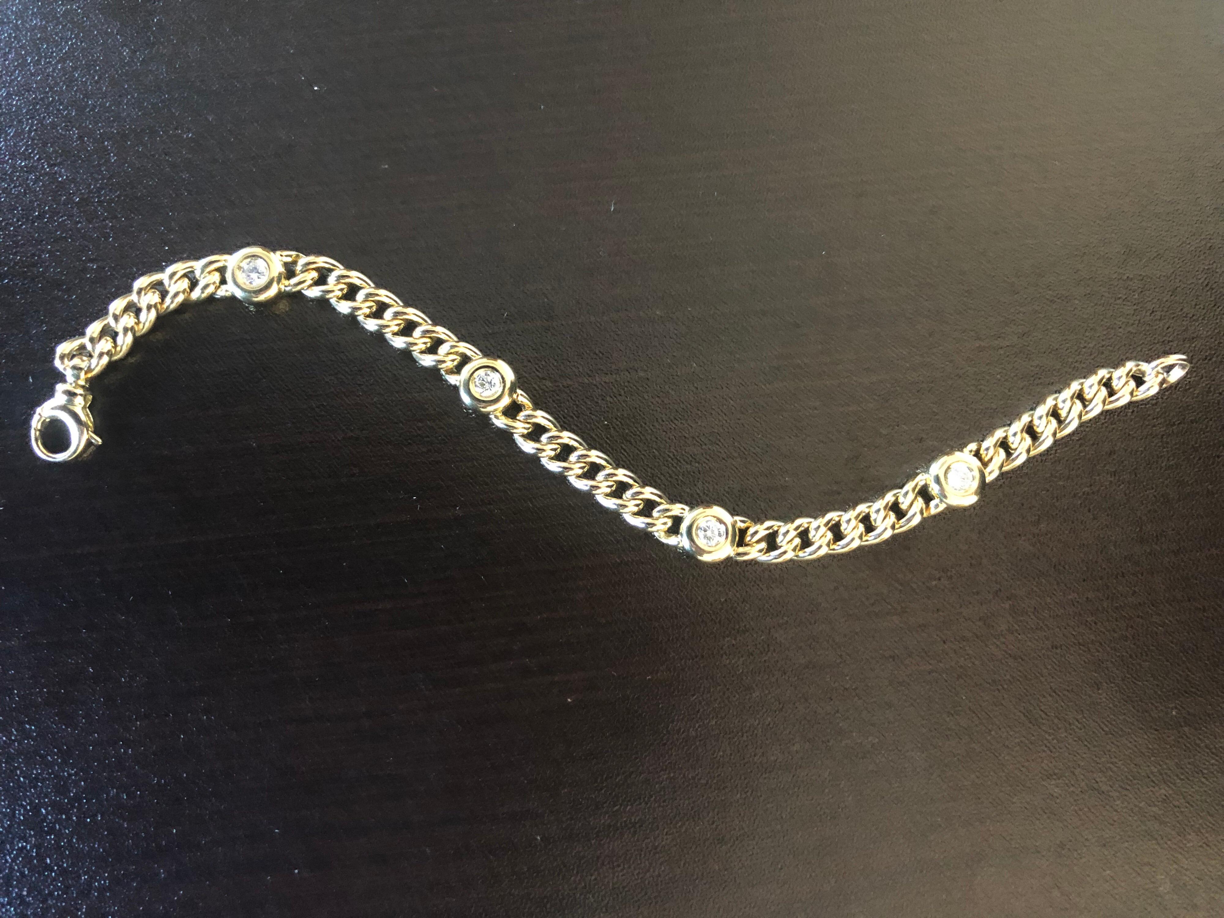Diamond bezel bracelet set in an 18K yellow gold Cuban chain. Each stone is set in a bezel weighing 0.15 carats each, the total weight is 0.60 carats. The color of the stones are G, the clarity is SI1-SI2.